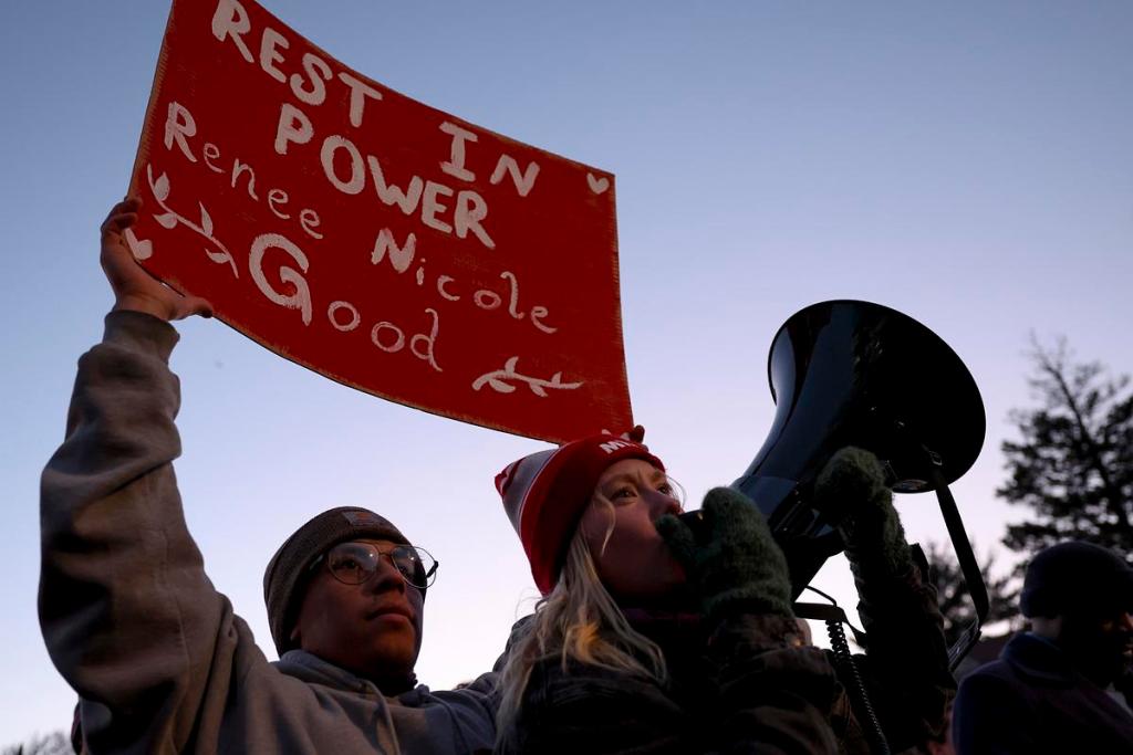 a protester holds up a red sign