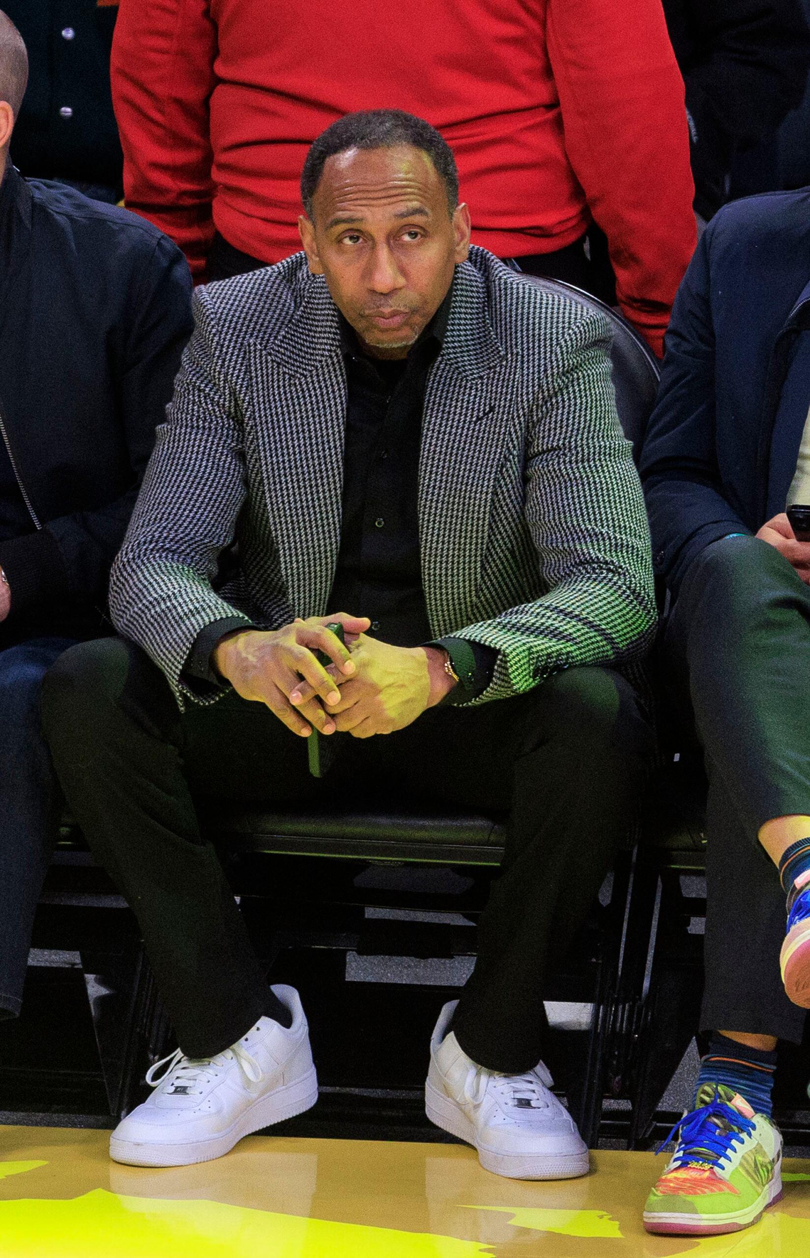 Stephen A. Smith sitting court side. 