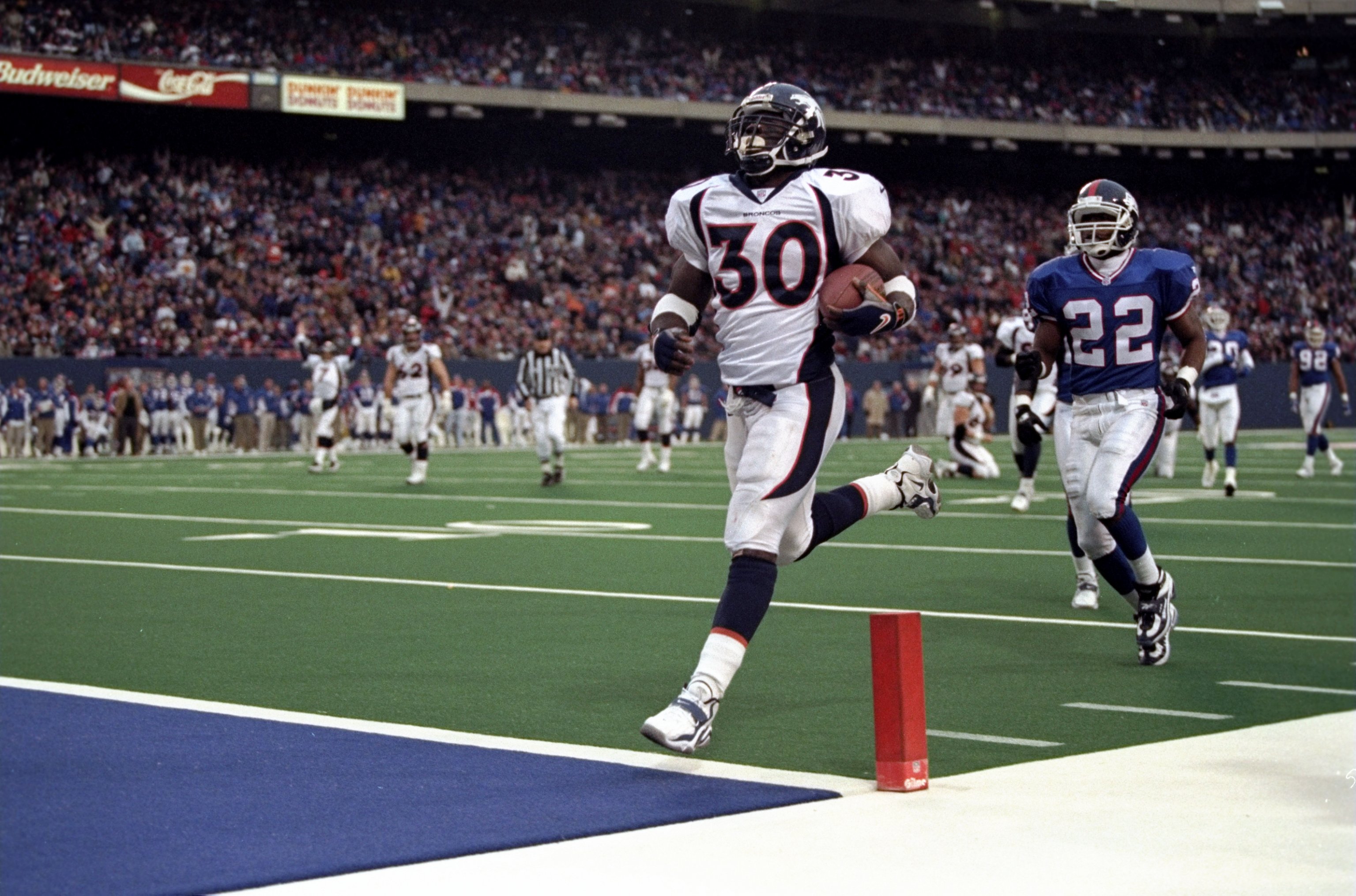 13 Dec 1998: Terrell Davis #30 of the Denver Broncos carries the ball for a touch down during the game against the New York Giants at Giants Stadium in East Rutherford , New Jersey. The Giants defeated the Broncos 21-16. Mandatory Credit: Al Bello /Allsport