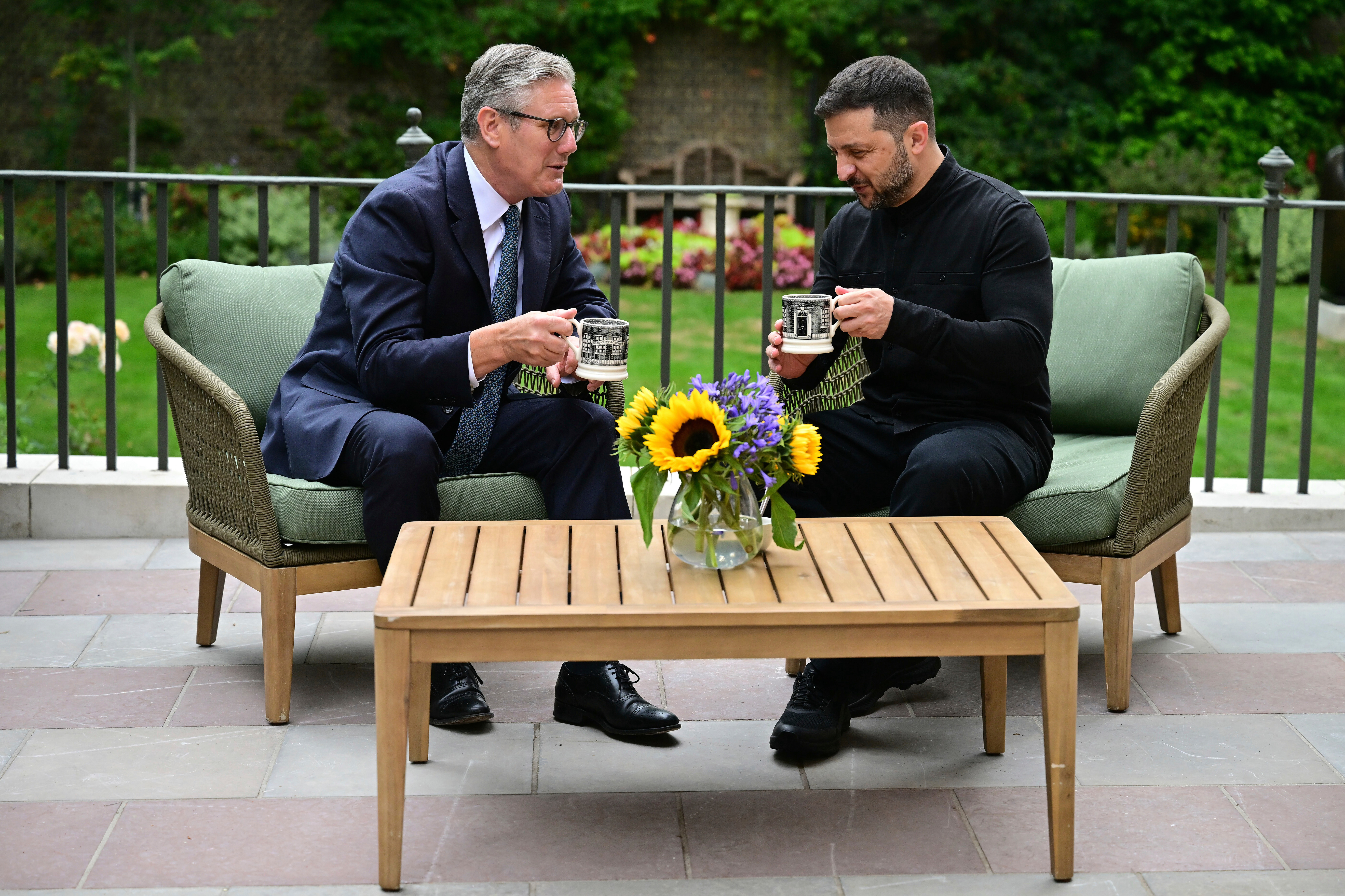 Britain's Prime Minister Keir Starmer, left, talks with Ukraine's President Volodymyr Zelenskyy in the garden of 10 Downing Street in London, Thursday Aug. 14, 2025. (Ben Stansall/Pool Photo via AP)