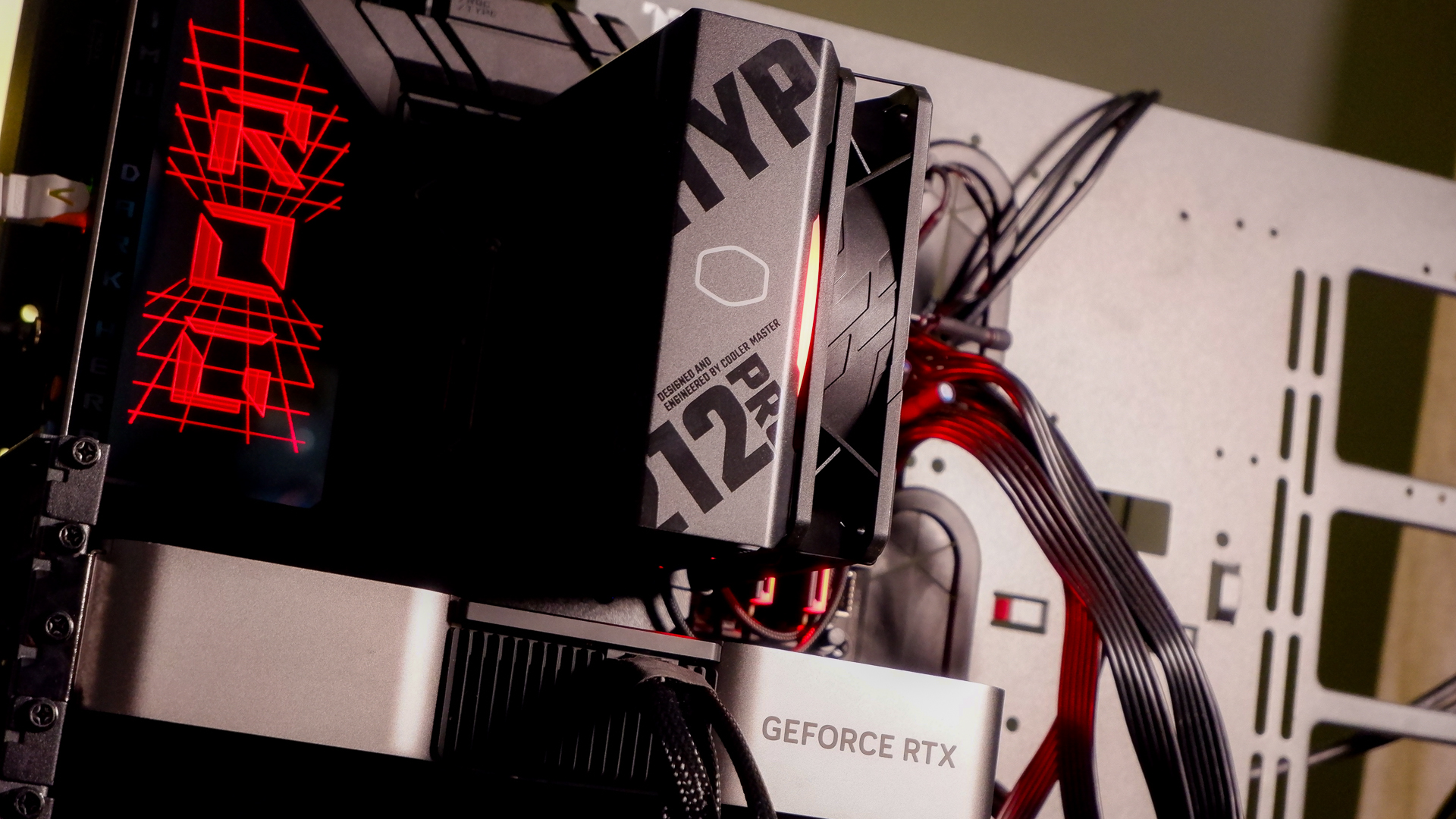 A Cooler Master Hyper 212 Pro air cooler with its packaging and installed on a gaming PC.