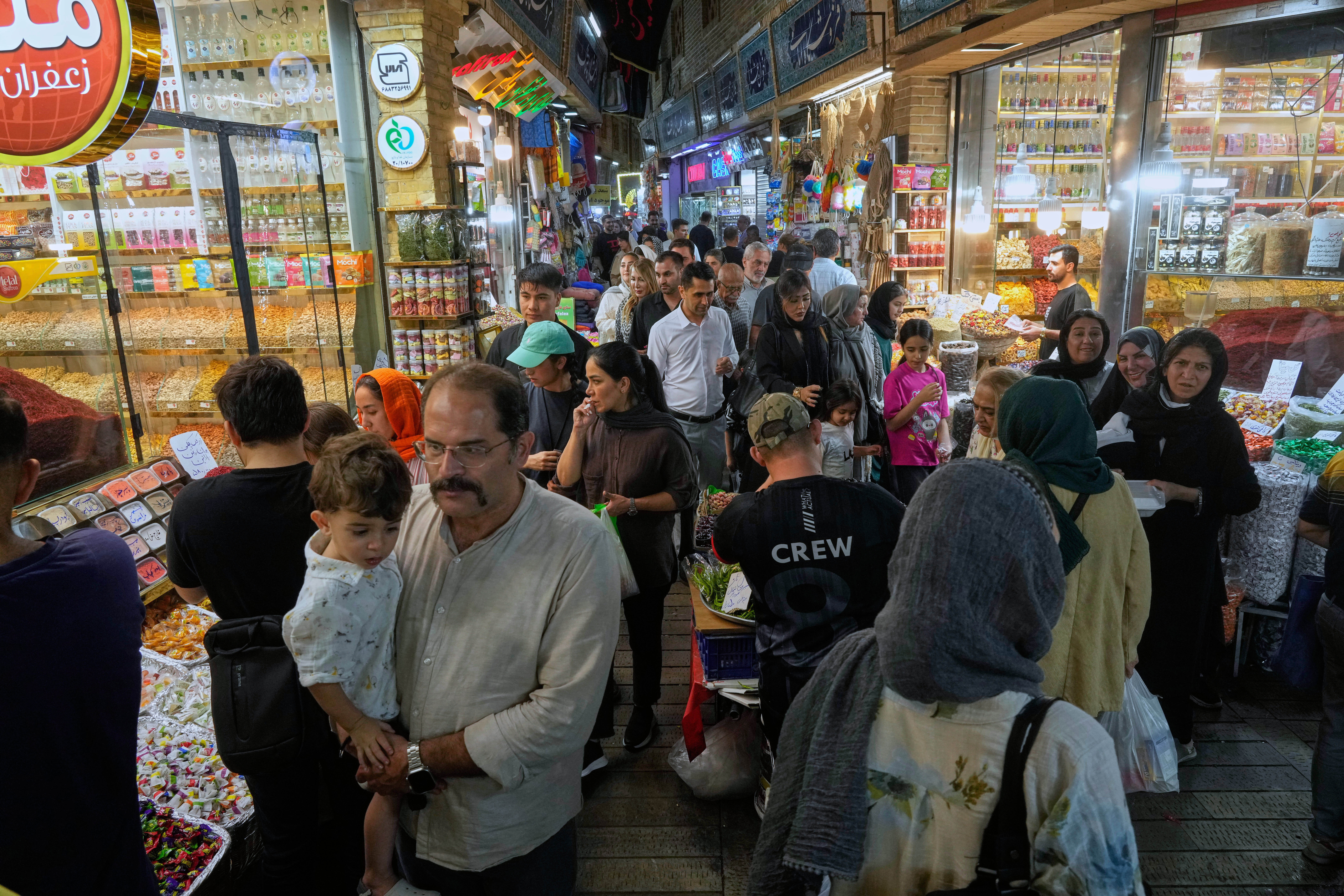 People walk at Tajrish traditional bazaar in northern Tehran, Iran, Thursday, Aug. 28, 2025. (AP Photo/Vahid Salemi)
