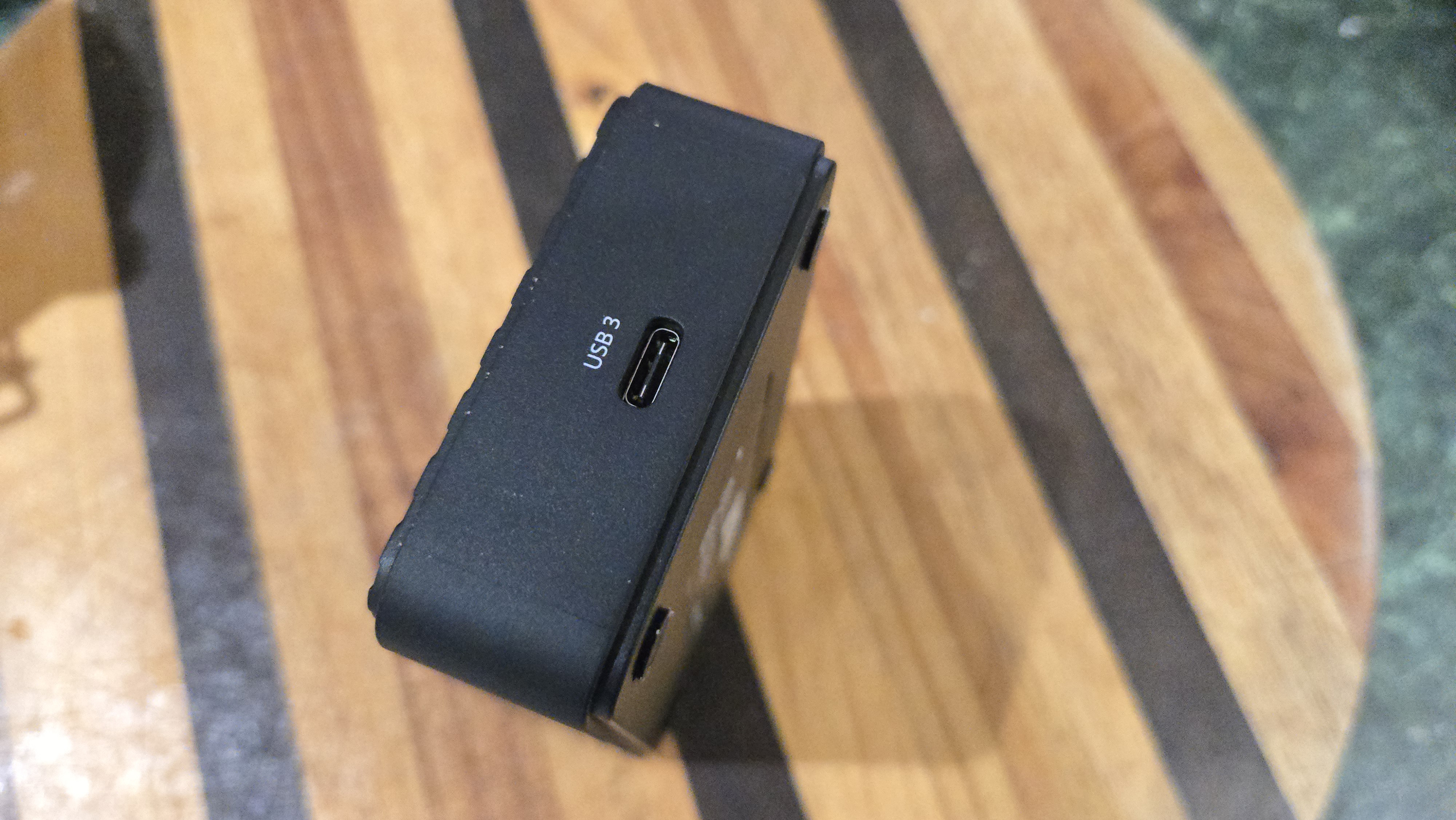 An AverMedia external capture card on a chair.