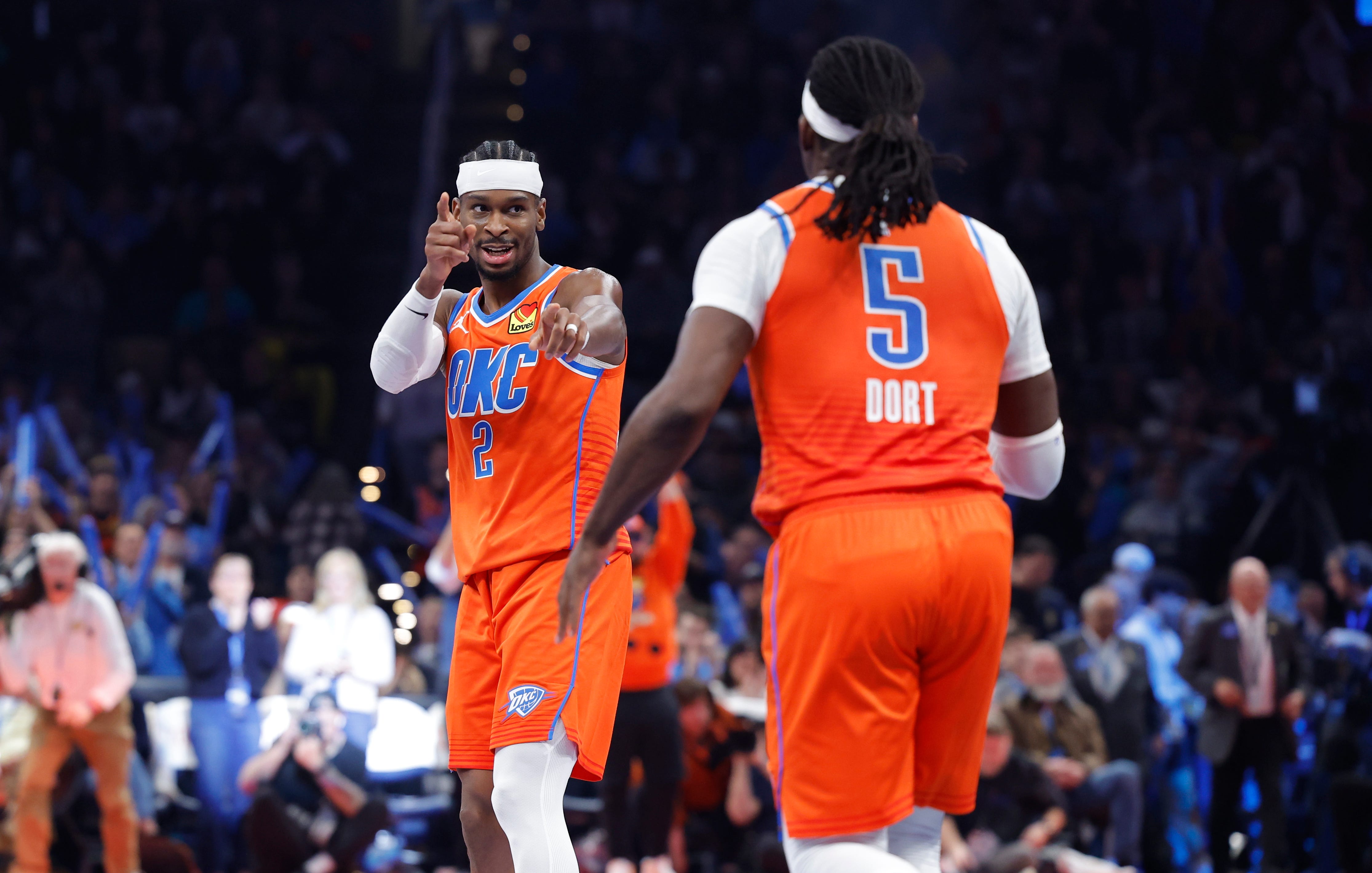 Nov 28, 2025; Oklahoma City, Oklahoma, USA; Oklahoma City Thunder guard Shai Gilgeous-Alexander (2) gestures towards guard Luguentz Dort (5) after a basket against the Phoenix Suns during the second half at Paycom Center. Mandatory Credit: Alonzo Adams-Imagn Images