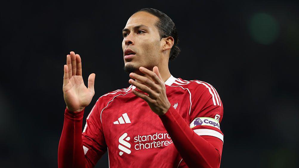 Virgil van Dijk applauds the Liverpool fans at Tottenham