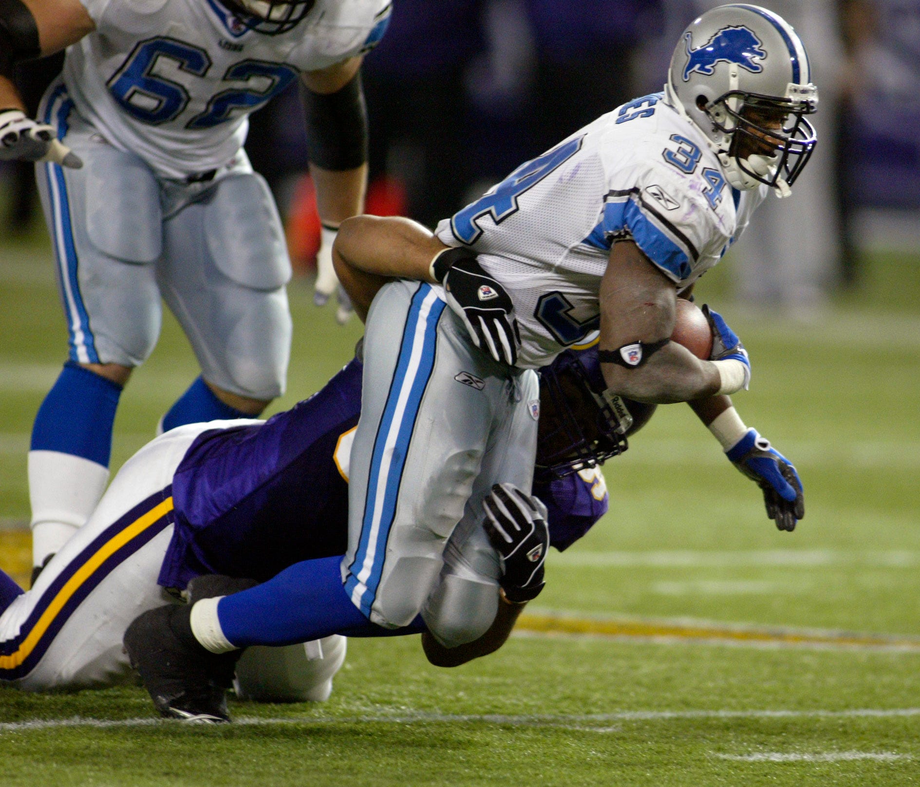 Minnesota Vikings cornerback Brian Williams tackles Detroit Lions running back Kevin Jones.