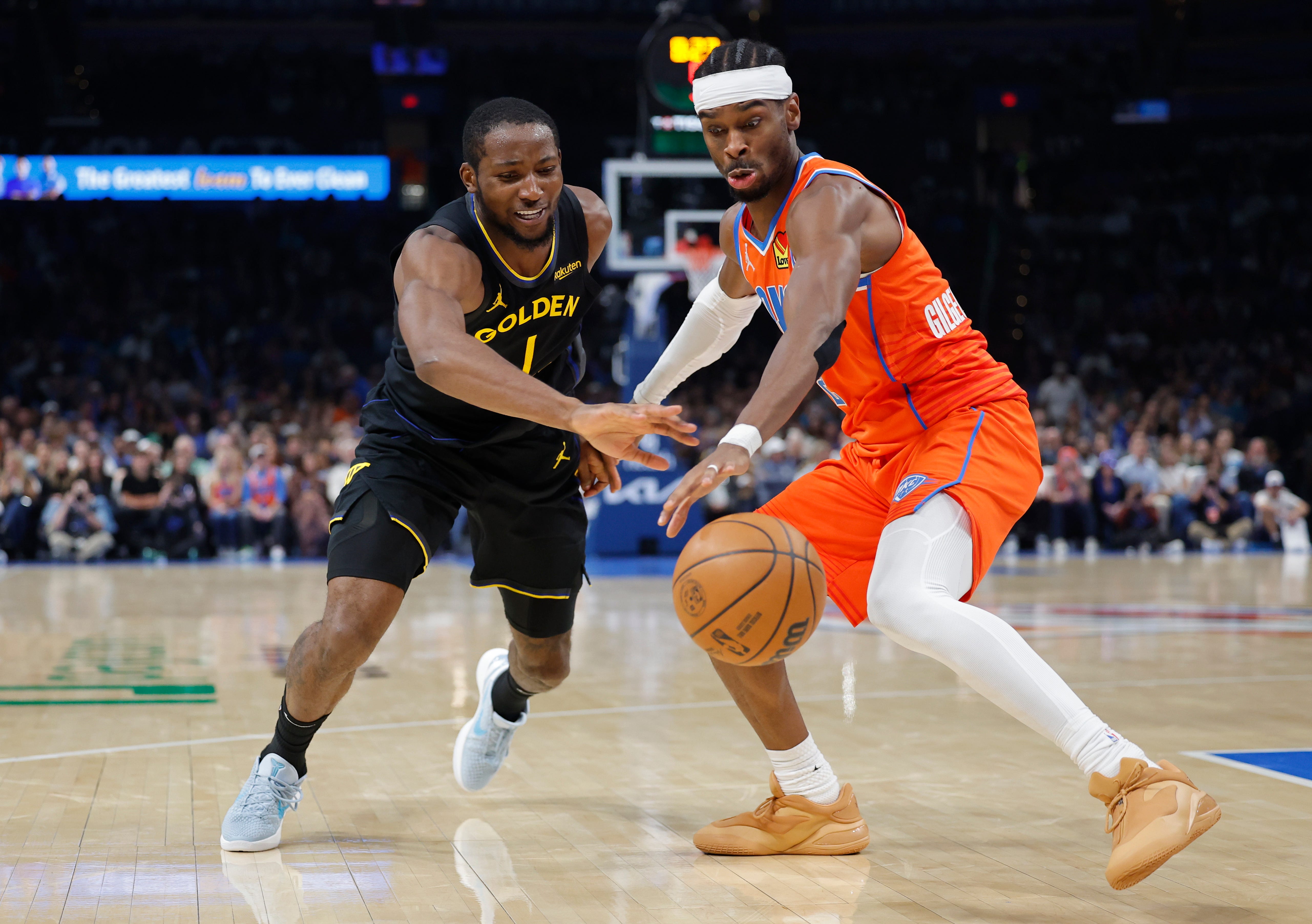 Nov 11, 2025; Oklahoma City, Oklahoma, USA; Golden State Warriors forward Jonathan Kuminga (1) and Oklahoma City Thunder guard Shai Gilgeous-Alexander (2) reach for a loose ball during the second half at Paycom Center. Mandatory Credit: Alonzo Adams-Imagn Images