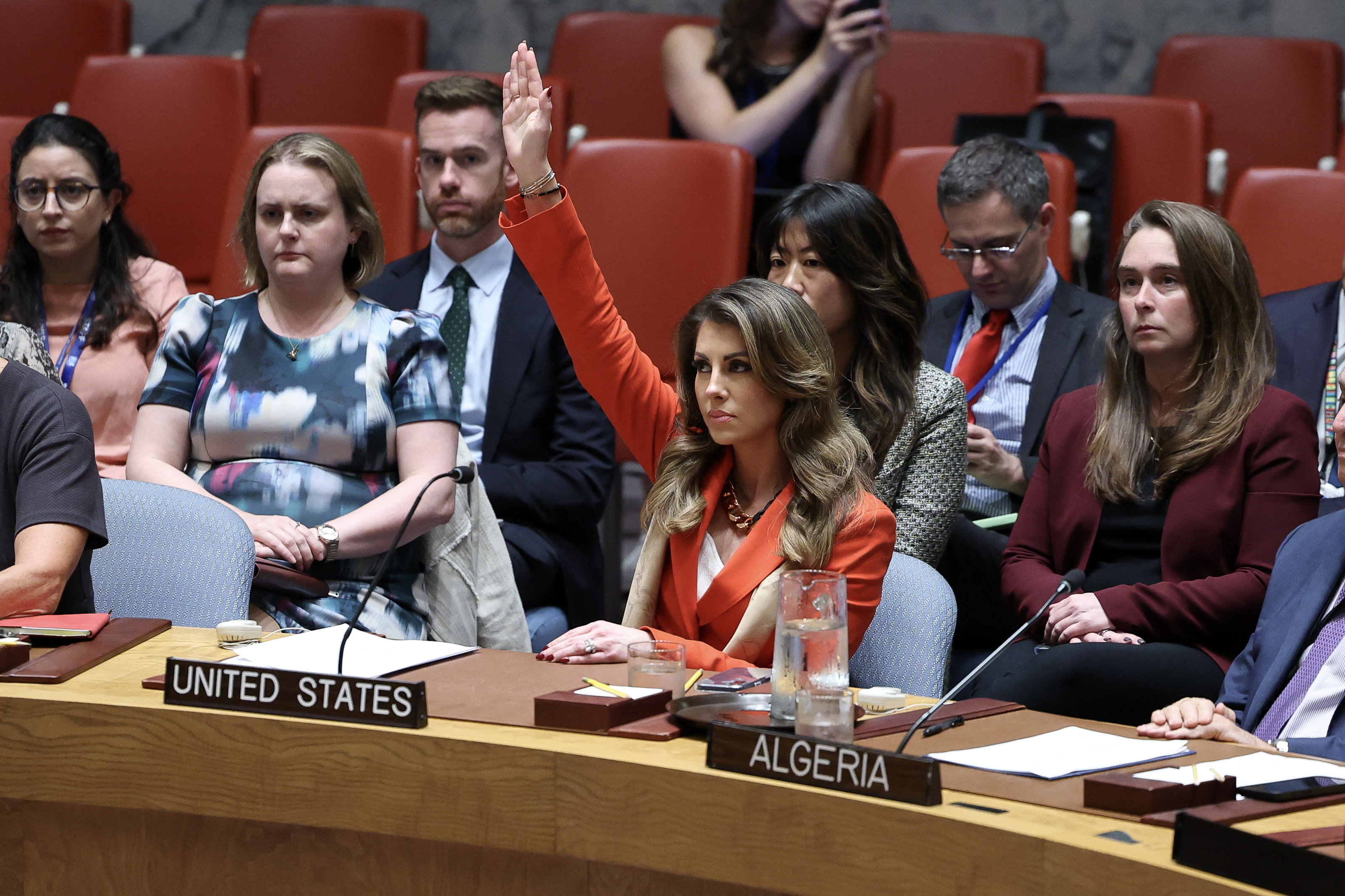 TOPSHOT - US deputy Middle East envoy Morgan Ortagus (C) raises her hand to veto a draft resolution during a United Nations Security Council meeting on the situation in Gaza, at UN headquarters in New York on September 18, 2025.