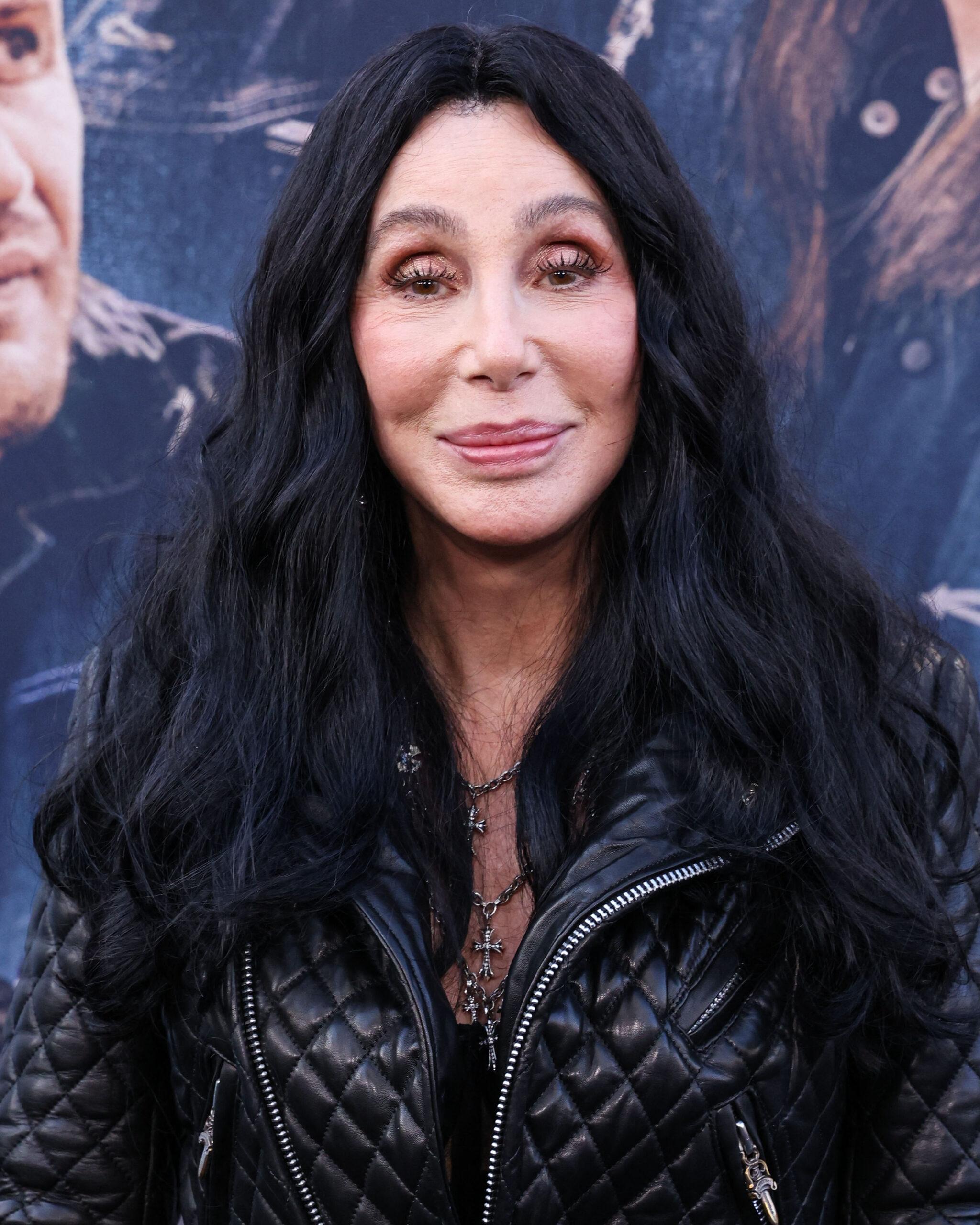Cher posing on the red carpet.