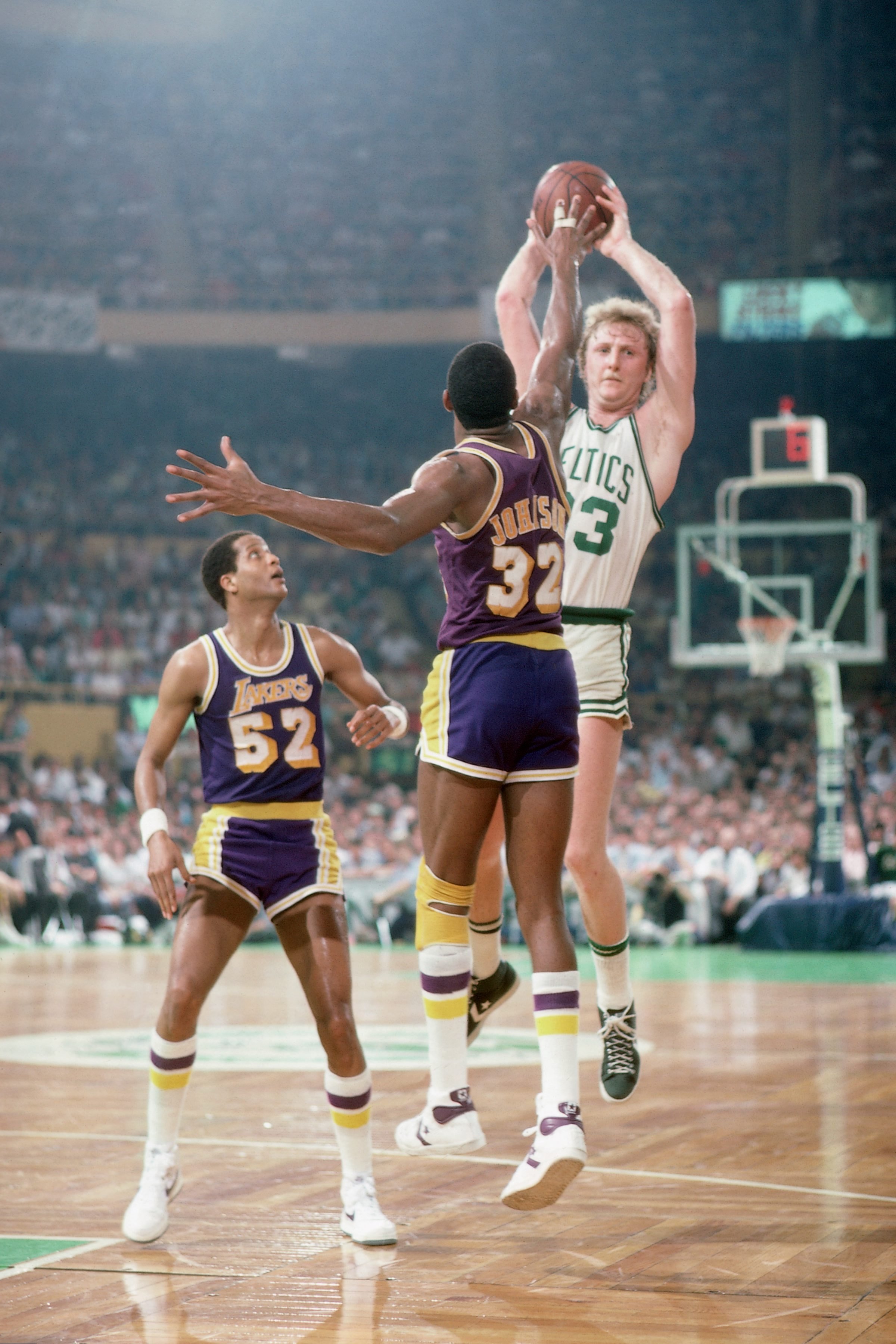 BOSTON - JUNE 8: Larry Bird #33 of the Boston Celtics passes against Magic Johnson #32 of the Los Angeles Lakers in Game Five of the 1984 NBA Finals played on June 8, 1984 at Boston Garden in Boston, Massachusetts. Boston defeated Los Angeles 121-103. NOTE TO USER: User expressly acknowledges that, by downloading and or using this photograph, User is consenting to the terms and conditions of the Getty Images License agreement. Mandatory Copyright Notice: Copyright 1984 NBAE (Photo by Dick Raphael/NBAE via Getty Images)