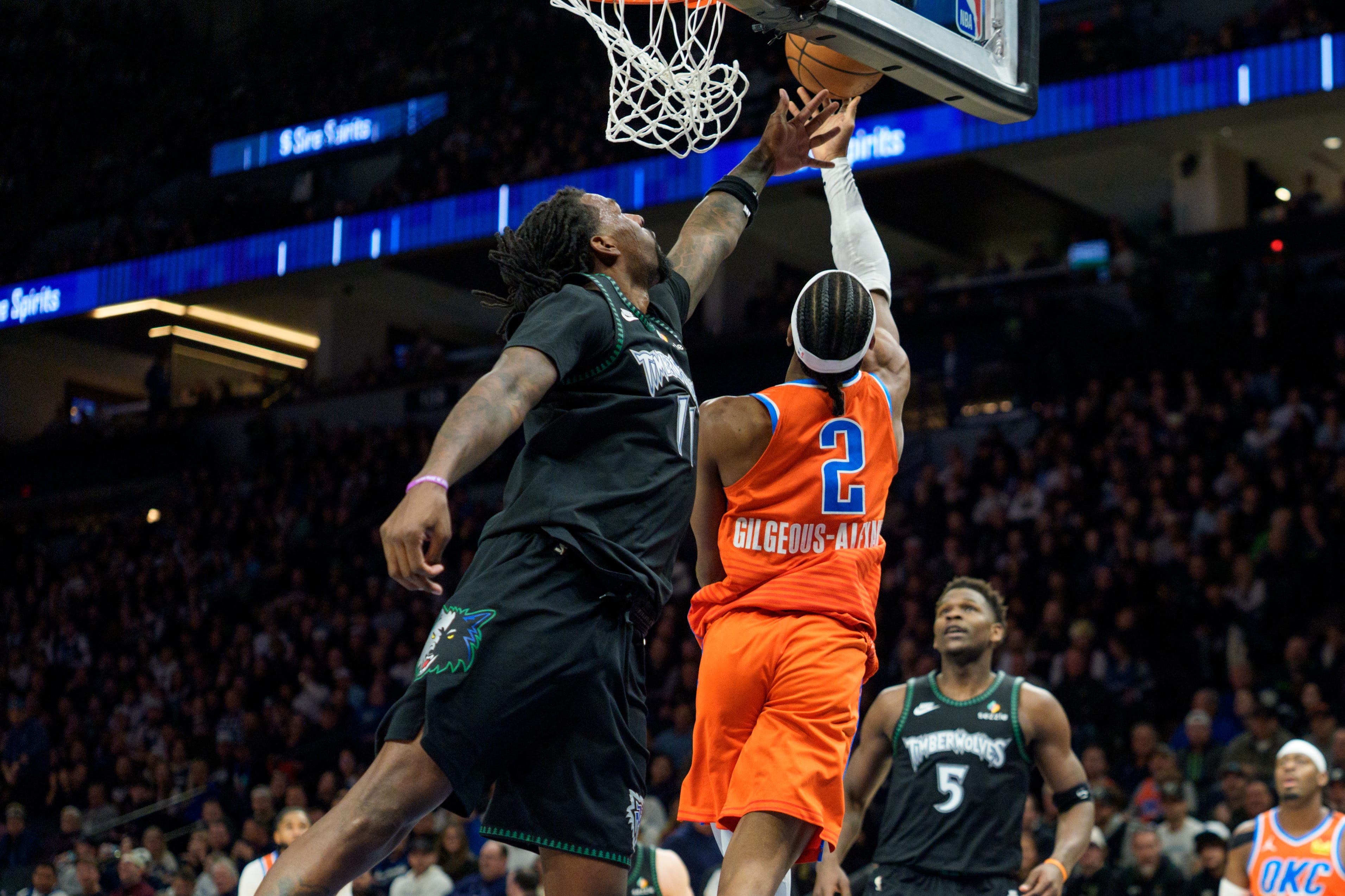 Jan 29, 2026; Minneapolis, Minnesota, USA; Oklahoma City Thunder guard Shai Gilgeous-Alexander (2) shoots over the defense of Minnesota Timberwolves center Naz Reid (11) in the fourth quarter at Target Center. Mandatory Credit: Matt Blewett-Imagn Images