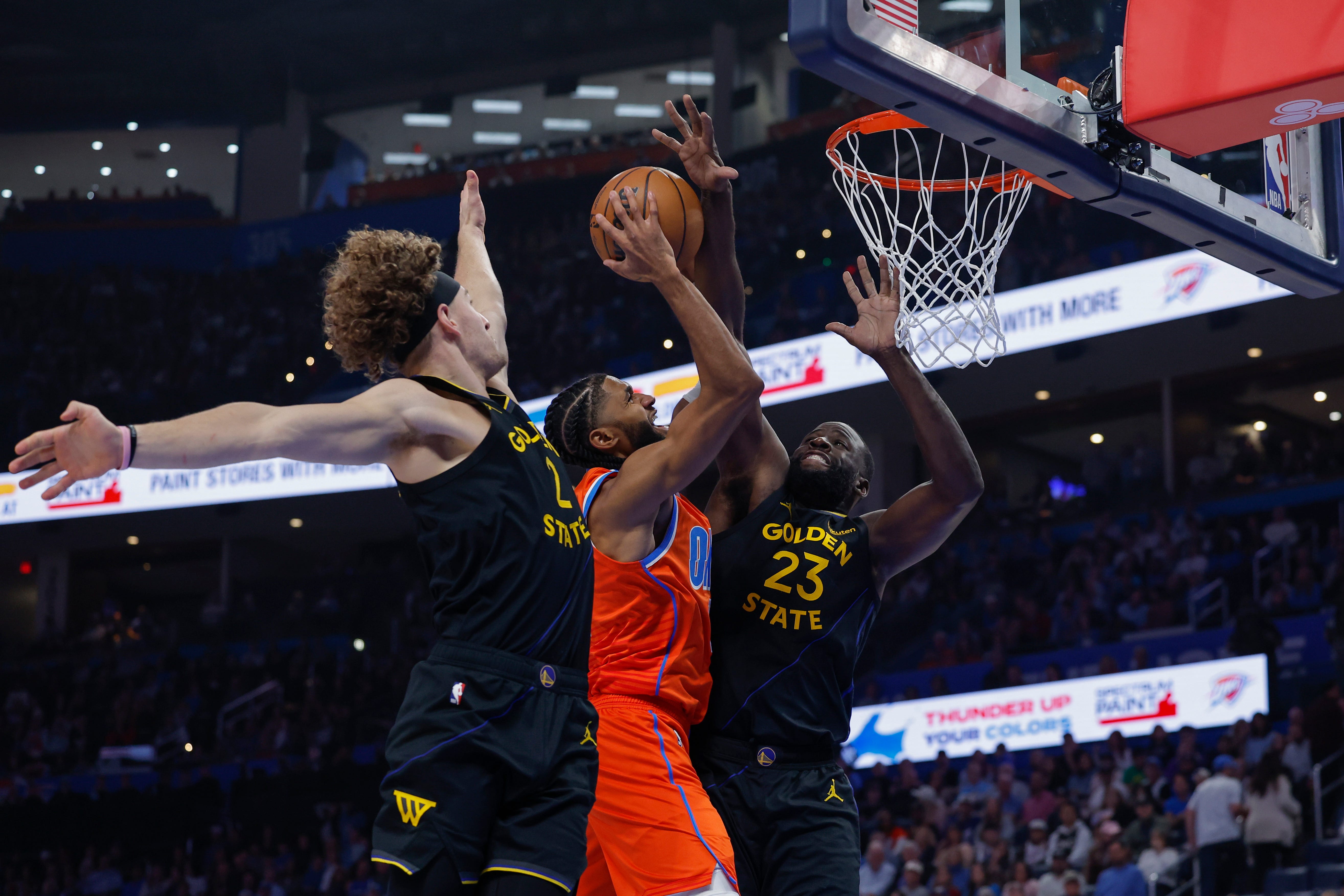 Nov 11, 2025; Oklahoma City, Oklahoma, USA; Oklahoma City Thunder guard Isaiah Joe (11) goes to the basket between Golden State Warriors guard Brandin Podziemski (2) and forward Draymond Green (23) during the second quarter at Paycom Center. Mandatory Credit: Alonzo Adams-Imagn Images
