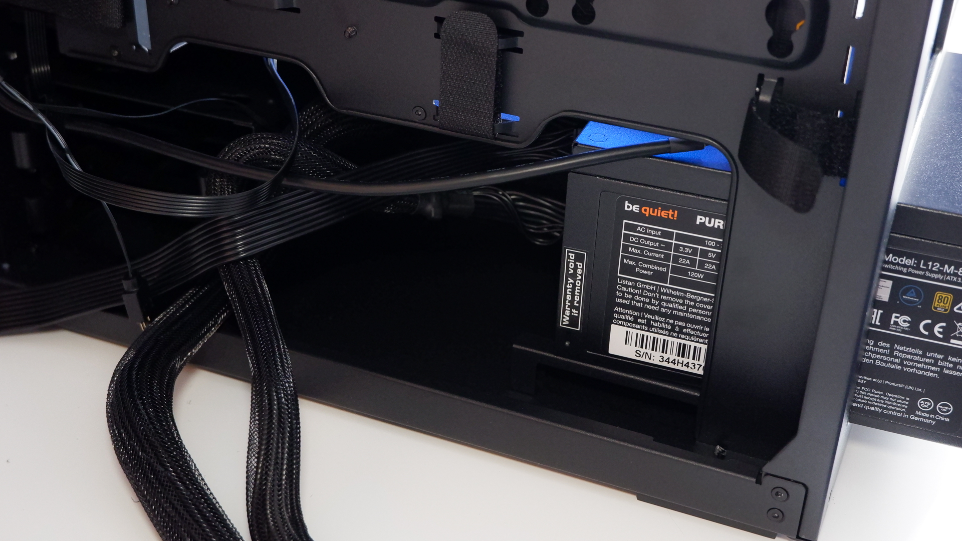 Arctic's Xtender PC case on a white desk with various parts being installed to build a functional gaming PC.