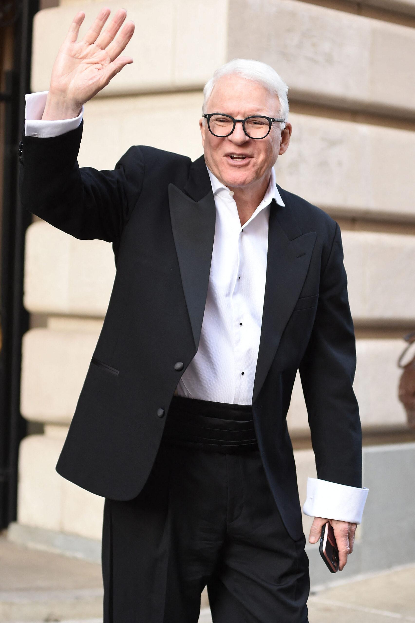 Steve Martin waves to fans as he seen leaving Only Murders in the building set