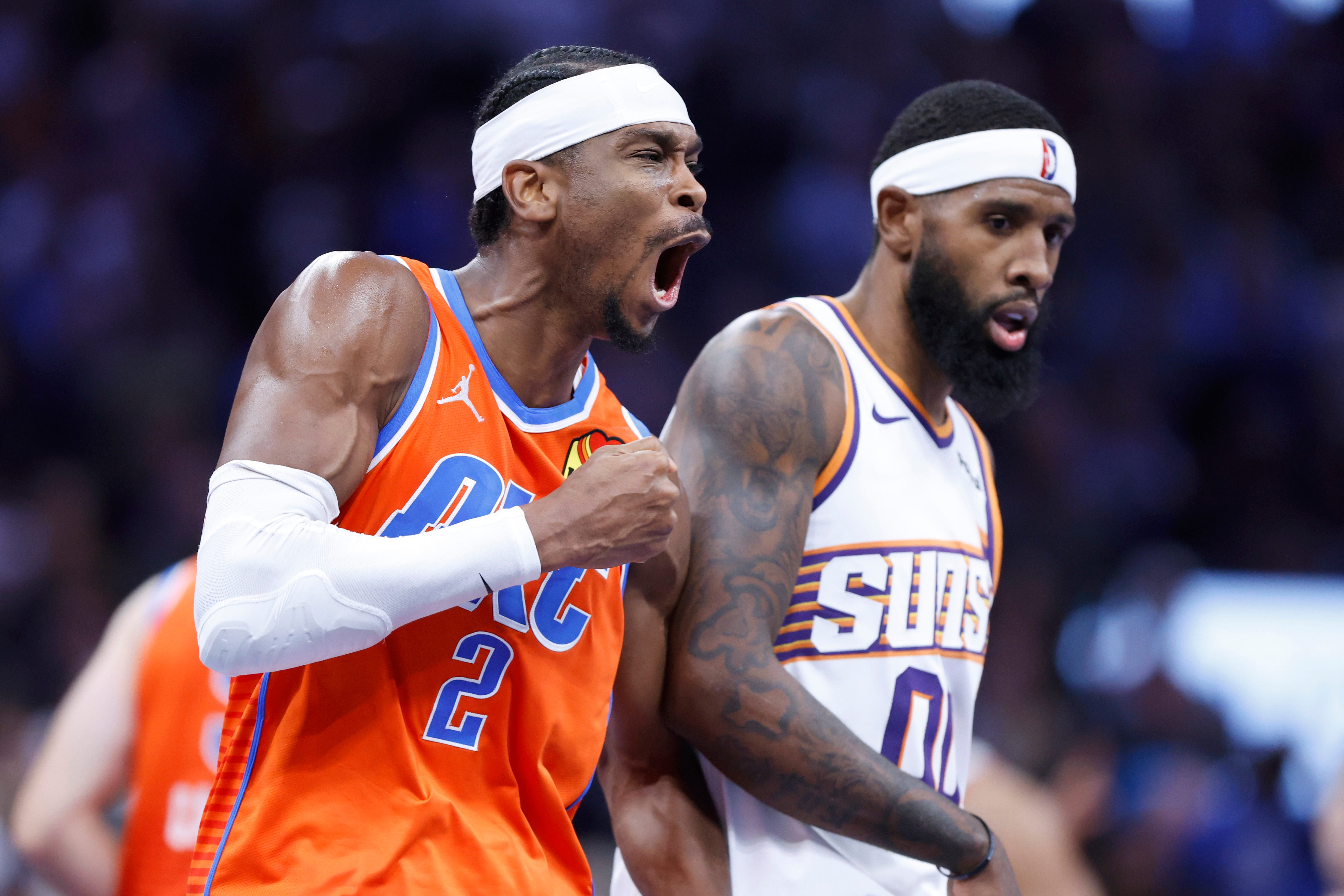Oklahoma City Thunder guard Shai Gilgeous-Alexander (2) celebrates beside Phoenix Suns forward Royce O'Neale (00) during an NBA Cup basketball game between the Oklahoma City Thunder and the Phoenix Suns at Paycom Center in Oklahoma City, Friday, Nov. 28, 2025. The Thunder won 123-119.