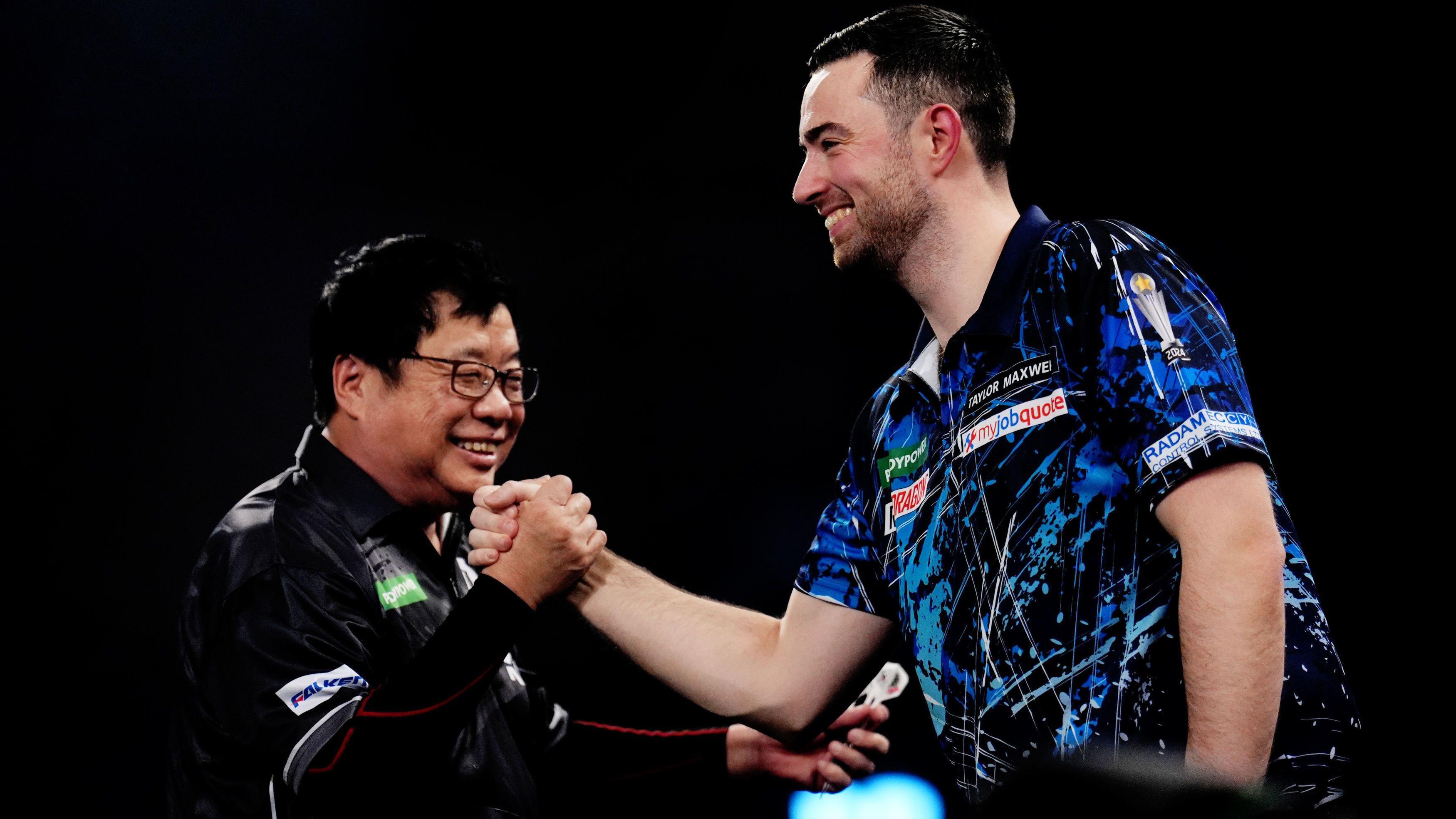 Luke Humphries shakes hands with Paul Lim