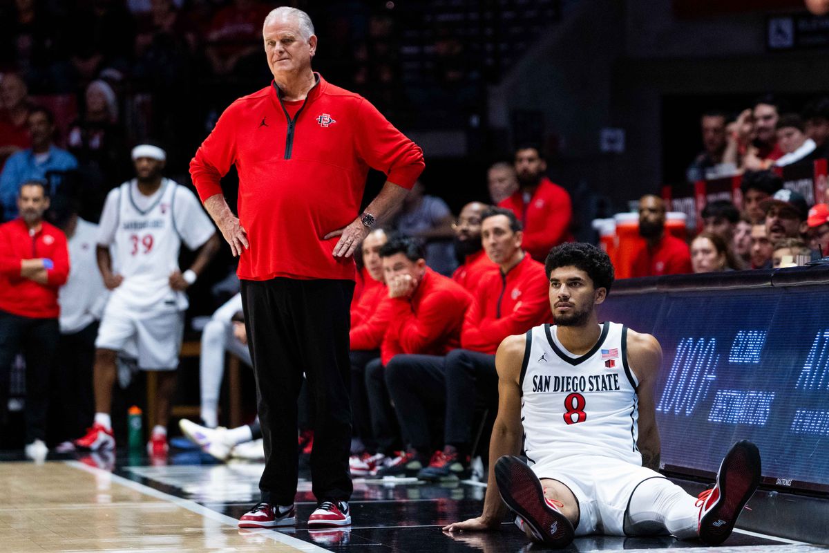 San Diego State forward Tae Simmons (8) sits next to San Diego State Head Coach Brian Dutcher during an NCAA Basketball game between Whittier and San Diego State, Monday December 22, 2025 at Viejas Arena in San Diego, Calif.