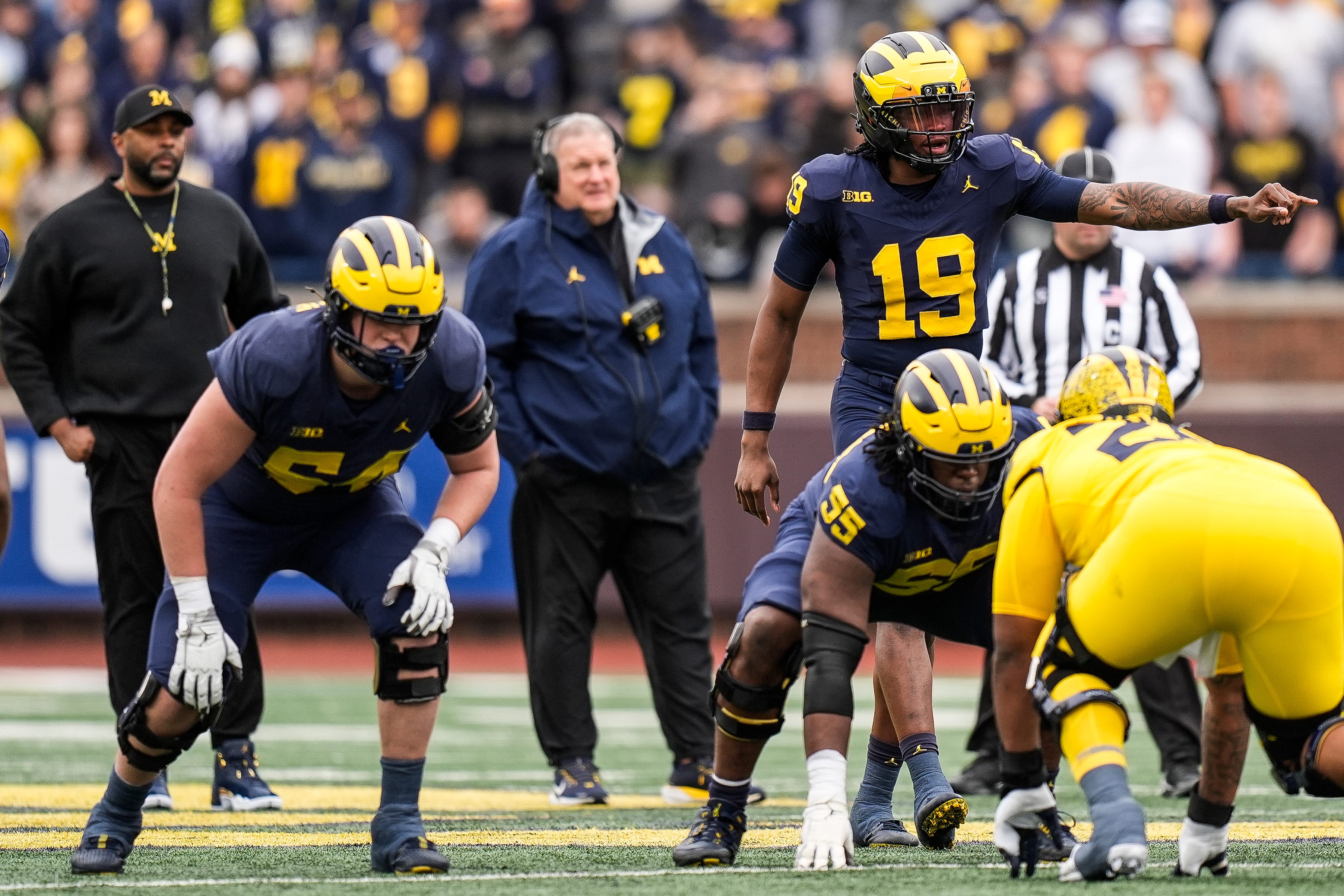 Michigan head coach Sherrone Moore, left, and associate head coach Biff Poggi watch quarterback Bryce Underwood (19) during the first half of the spring game at Michigan Stadium in Ann Arbor on Saturday, April 19, 2025.