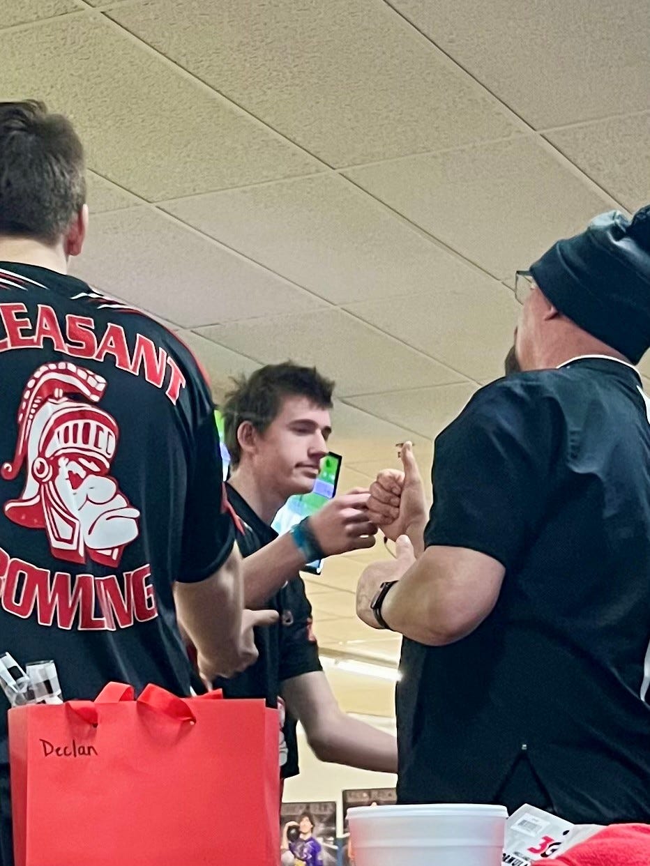 Pleasant's Tucker Ludwig fist bumps his father and bowling coach Bill Ludwig during the Division II boys bowling state tournament at HP Lanes in Columbus Feb. 27, 2026.