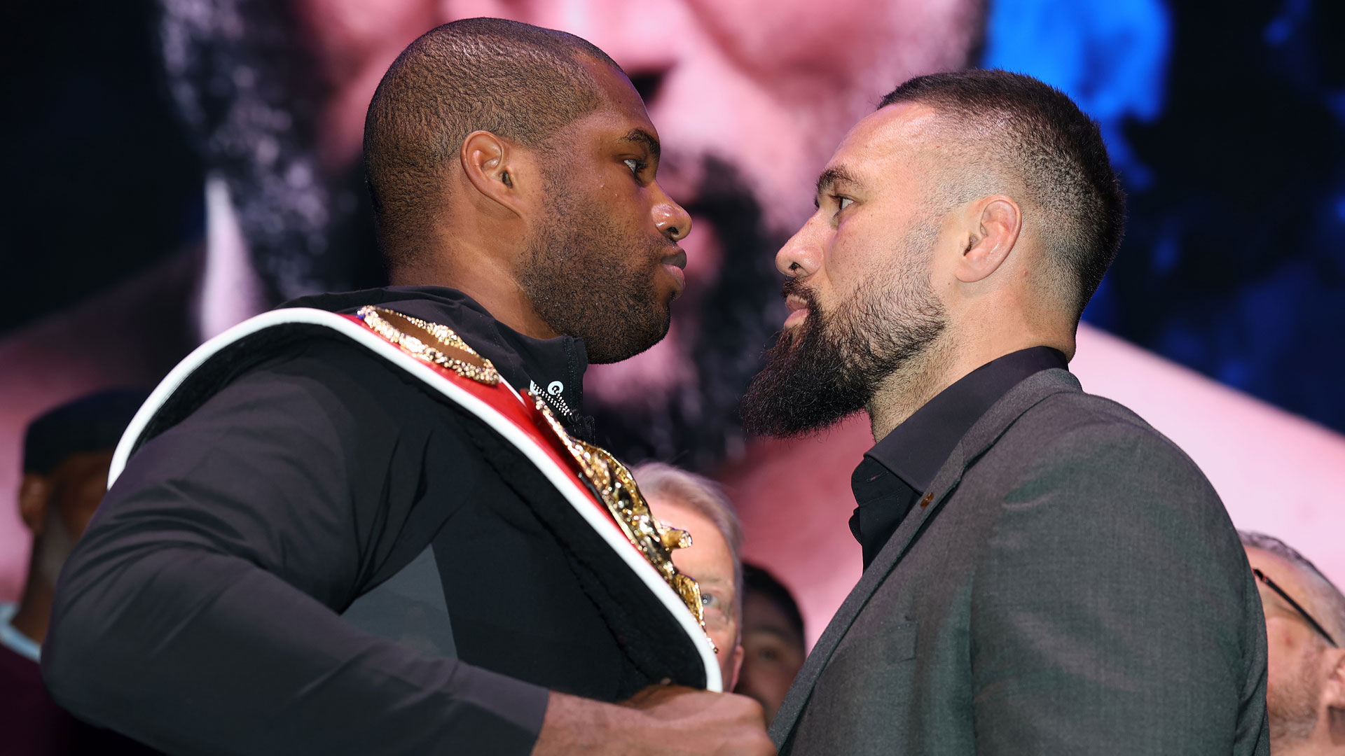 Two boxers facing each other at a press conference.