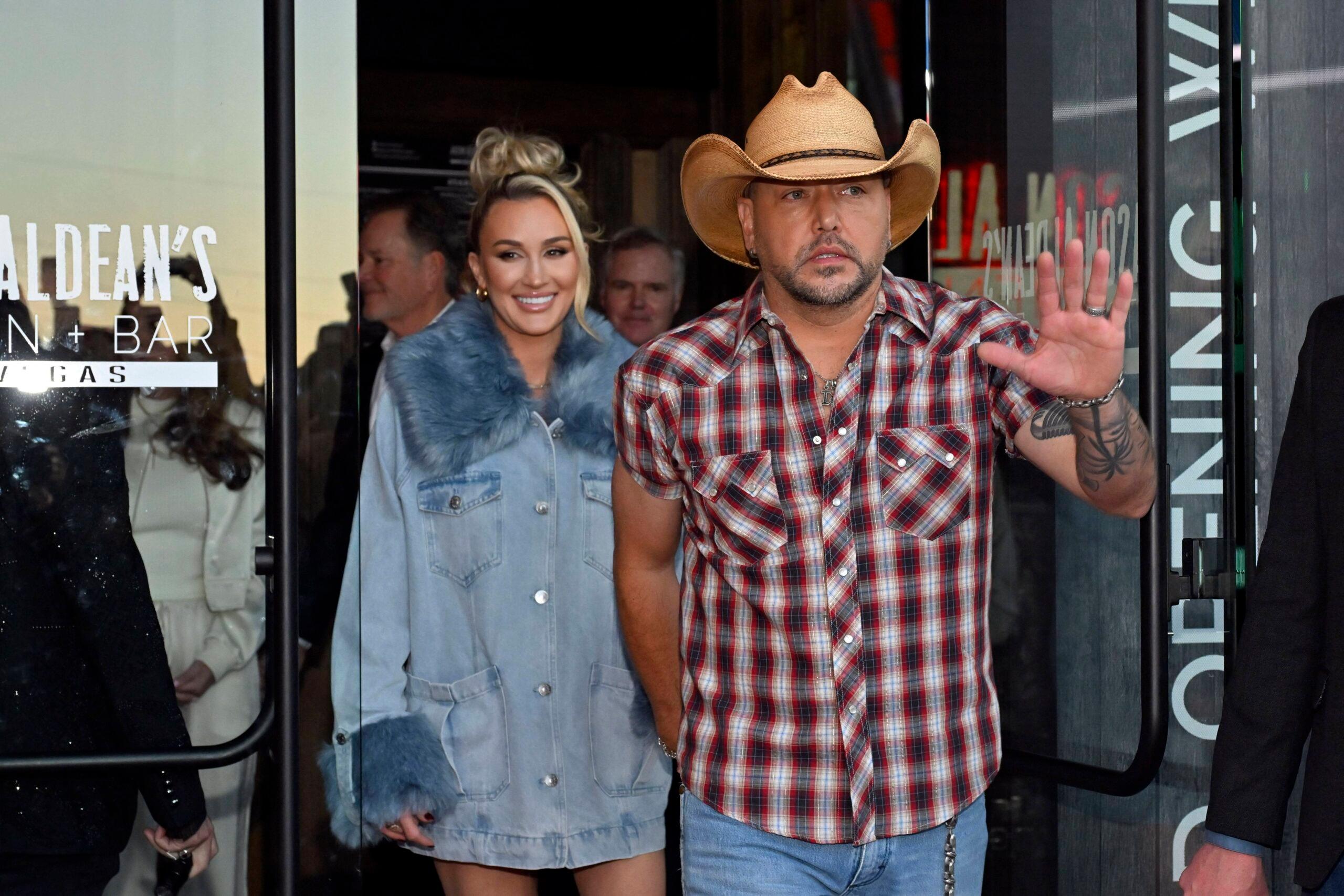 Brittany Aldean (L) and Jason Aldean arrive at the grand opening of Jason Aldean's Kitchen