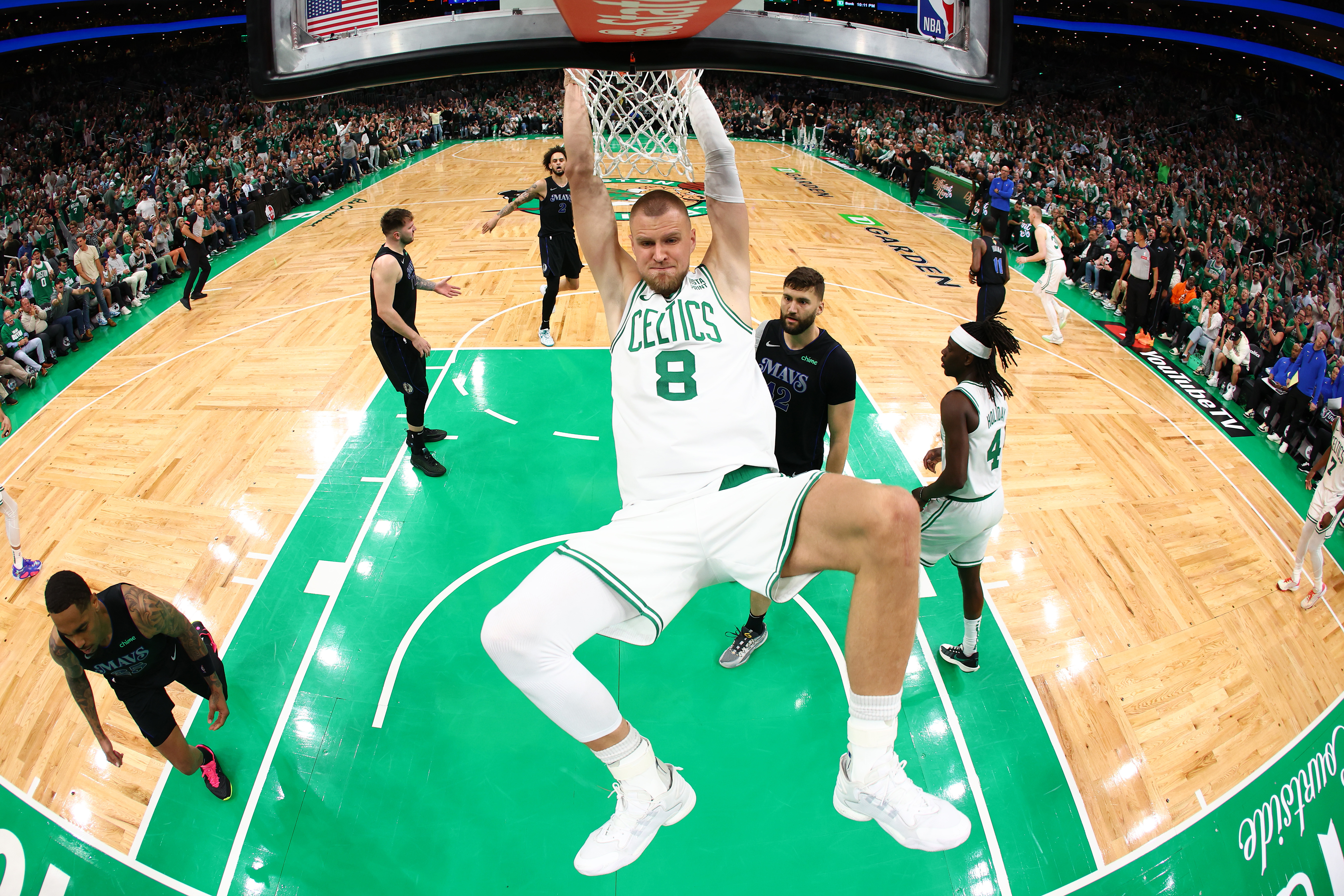 BOSTON, MASSACHUSETTS - JUNE 06: Kristaps Porzingis #8 of the Boston Celtics dunks the ball during the first quarter against the Dallas Mavericks in Game One of the 2024 NBA Finals at TD Garden on June 06, 2024 in Boston, Massachusetts. NOTE TO USER: User expressly acknowledges and agrees that, by downloading and or using this photograph, User is consenting to the terms and conditions of the Getty Images License Agreement. (Photo by Maddie Meyer/Getty Images)