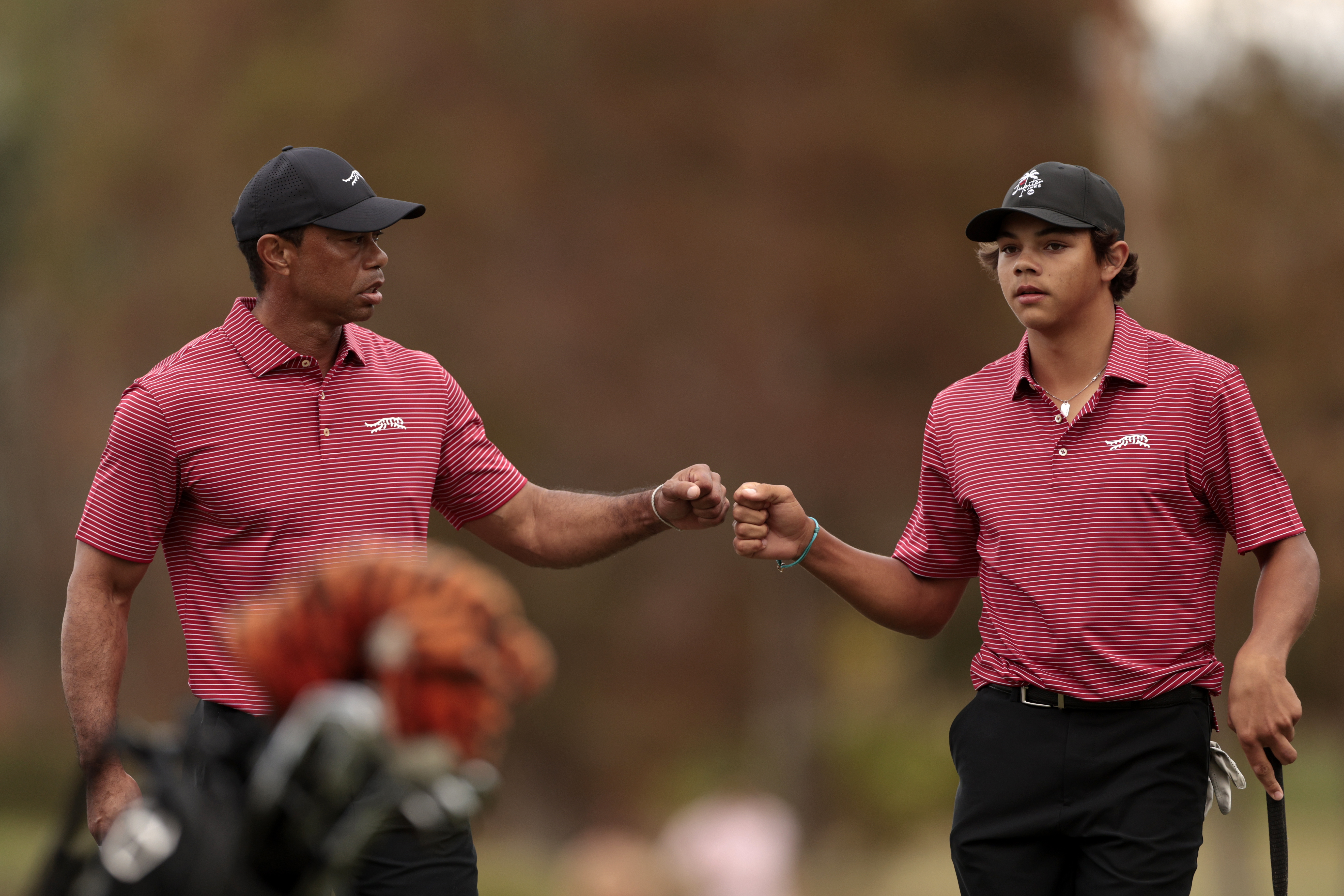 ORLANDO, FLORIDA - DECEMBER 22: Tiger Woods of the United States and his son Charlie Woods react on the 16th green during the second round of the PNC Championship at Ritz-Carlton Golf Club on December 22, 2024 in Orlando, Florida. (Photo by Douglas P. DeFelice/Getty Images)