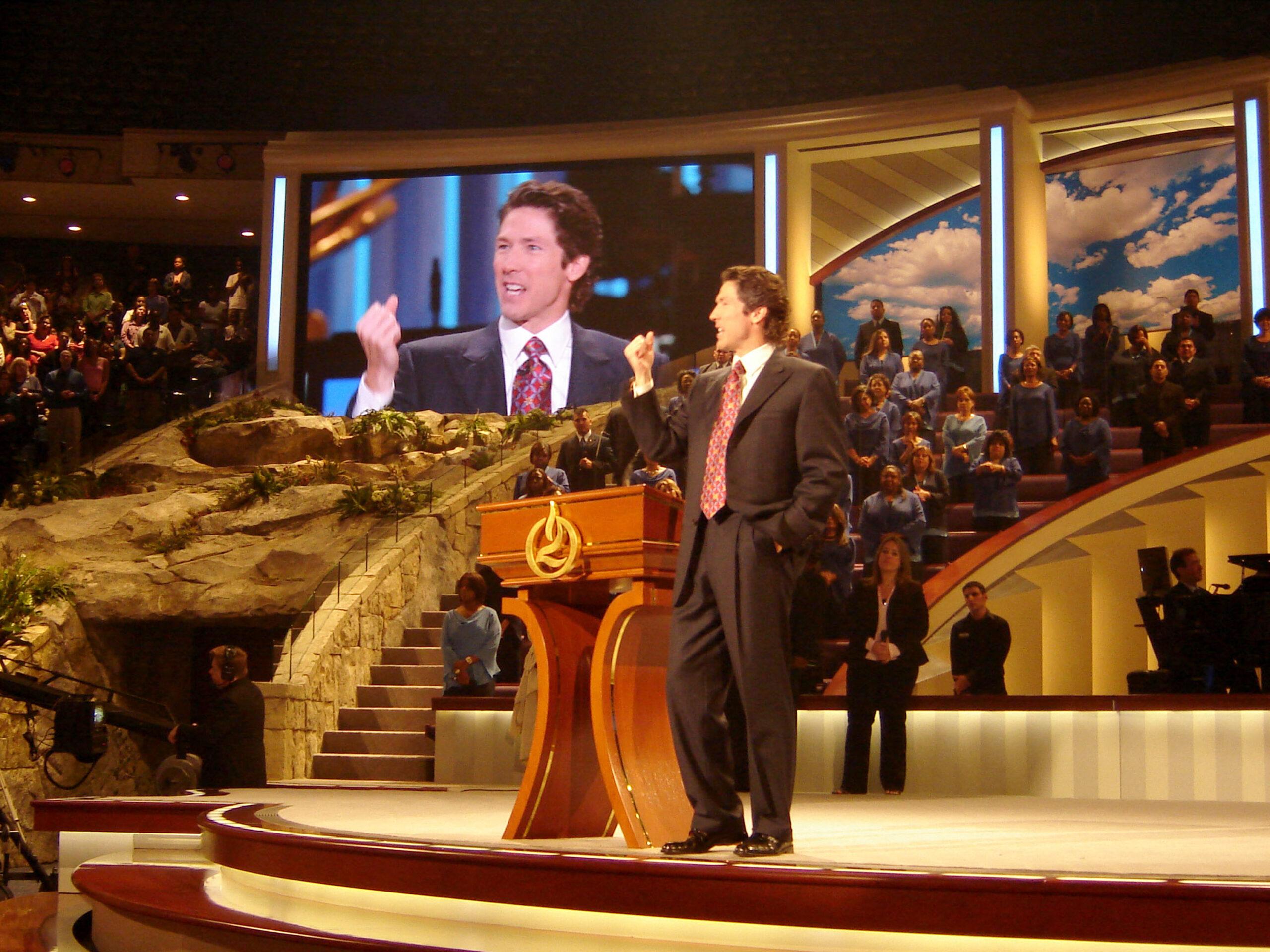 Joel Osteen preaching inside of his Lakewood church. 