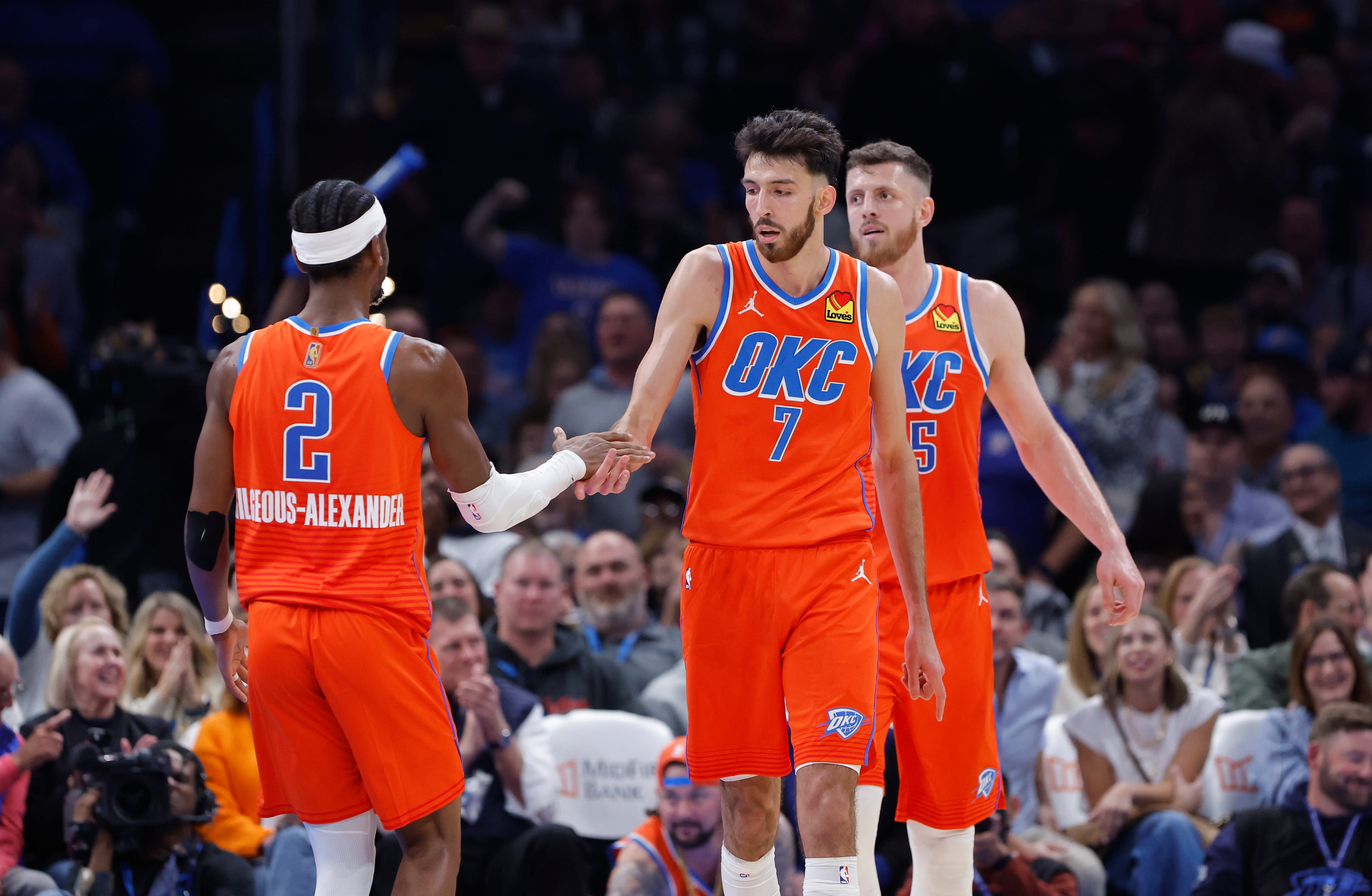 Nov 11, 2025; Oklahoma City, Oklahoma, USA; Oklahoma City Thunder center Chet Holmgren (7) and Oklahoma City Thunder guard Shai Gilgeous-Alexander (2) celebrate after scoring against the Golden State Warriors during the second half at Paycom Center. Mandatory Credit: Alonzo Adams-Imagn Images