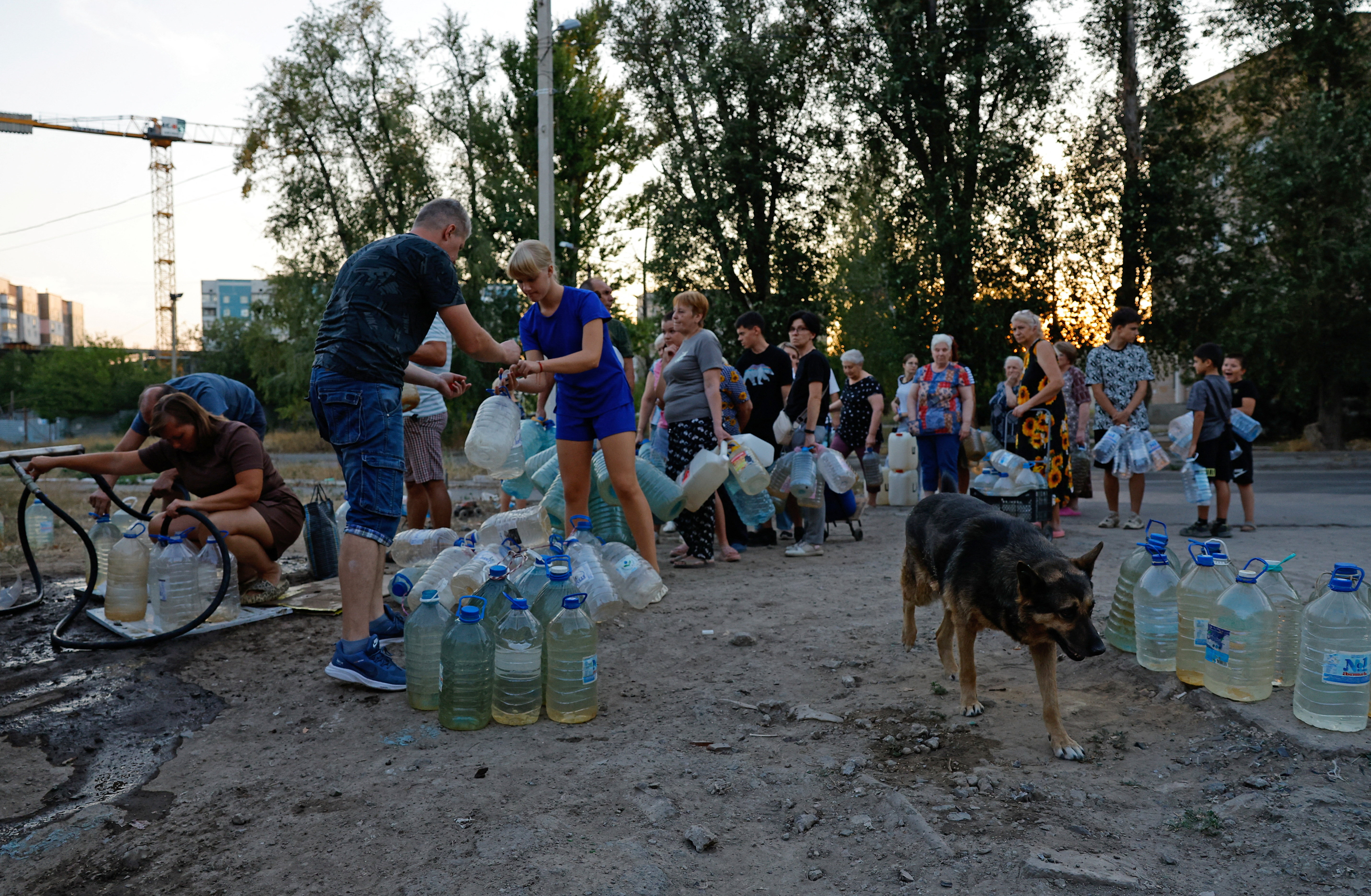 Local residents wait in line to collect water delivered by a tank truck in the course of Russia-Ukraine military conflict, in Donetsk, a Russian-controlled city of Ukraine, August 21, 2025. REUTERS/Alexander Ermochenko