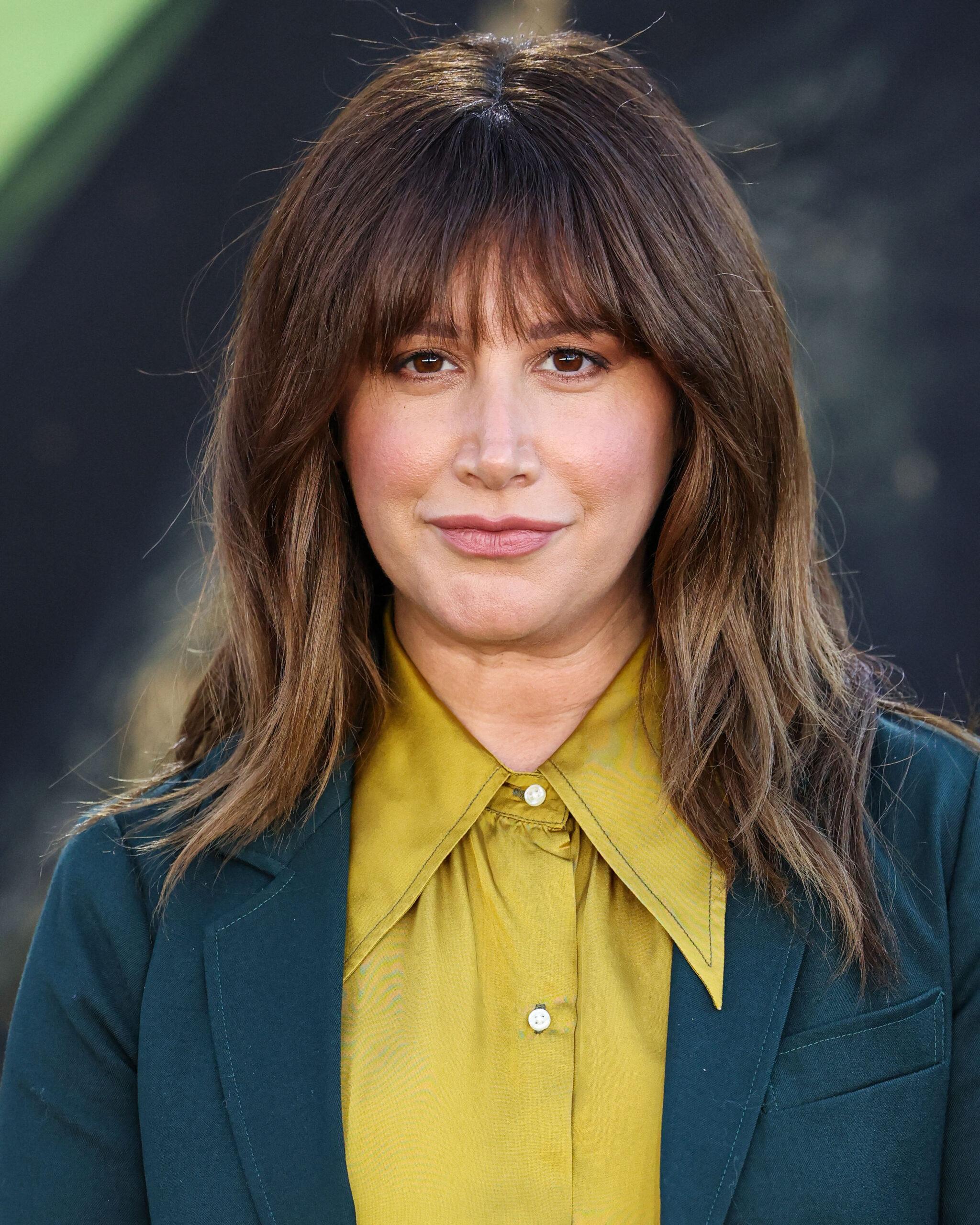 Ashley Tisdale posing on the red carpet.