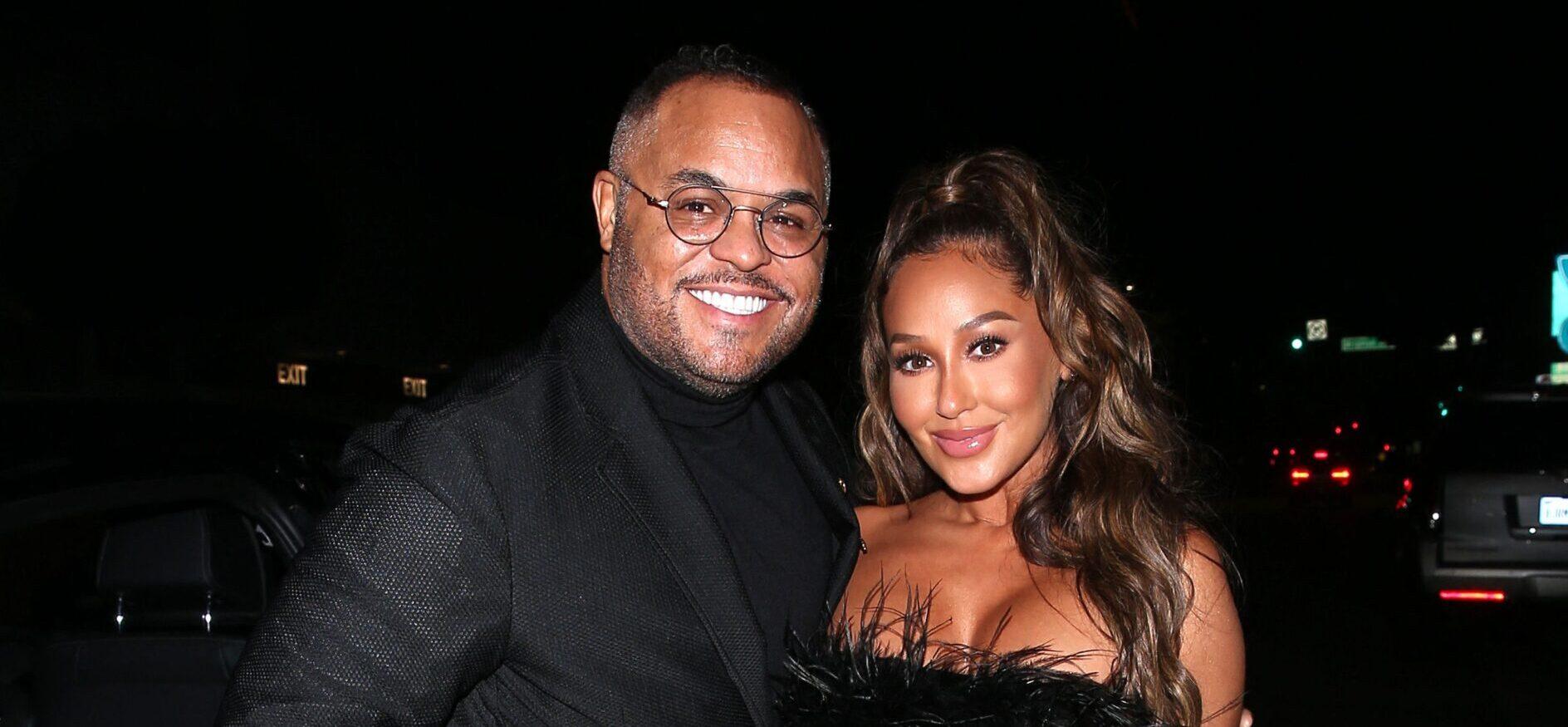 Adrienne Bailon and Israel Houghton posing together for a photo.