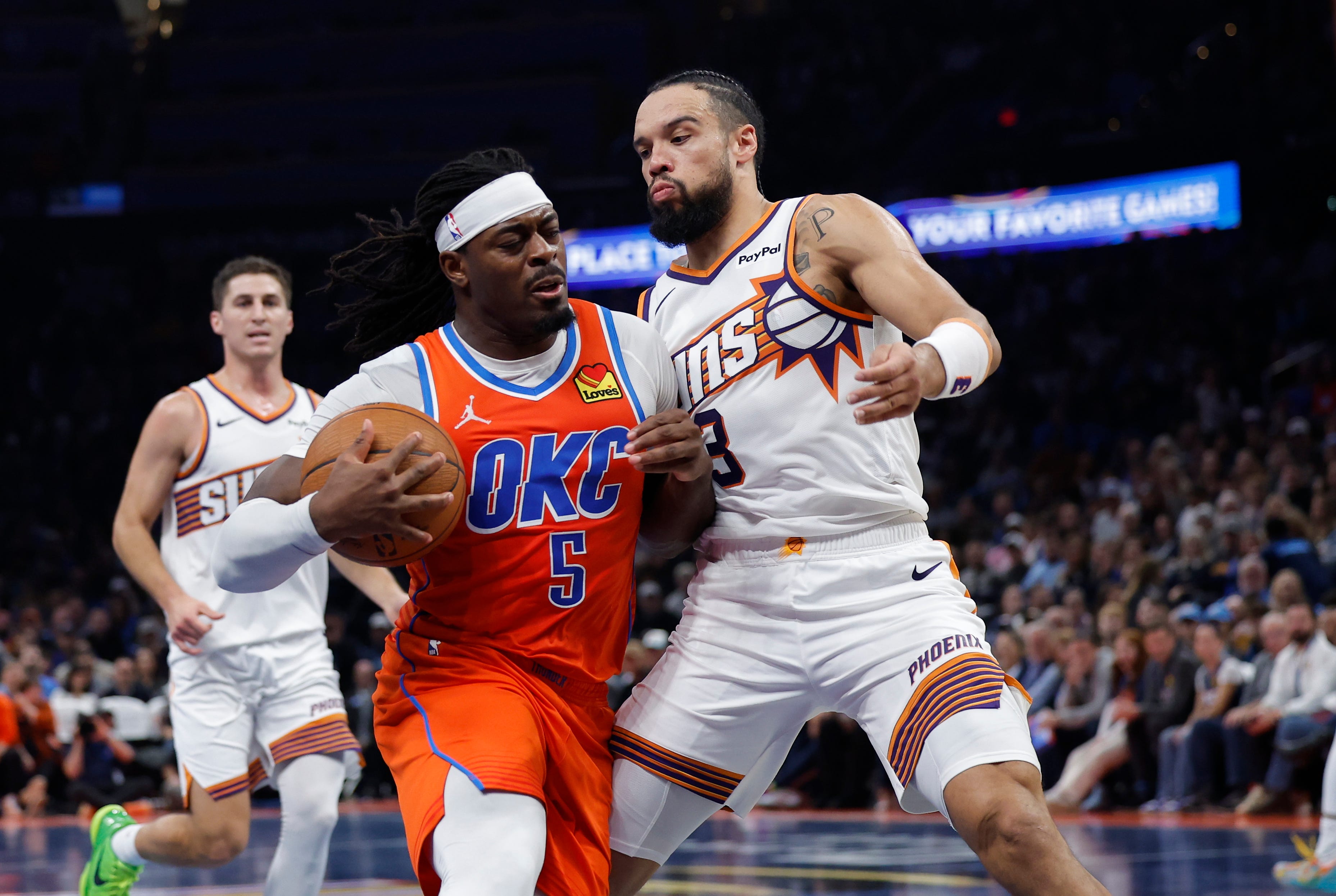 Nov 28, 2025; Oklahoma City, Oklahoma, USA; Oklahoma City Thunder guard Luguentz Dort (5) drives to the basket against Phoenix Suns forward Dillon Brooks (3) during the second half at Paycom Center. Mandatory Credit: Alonzo Adams-Imagn Images
