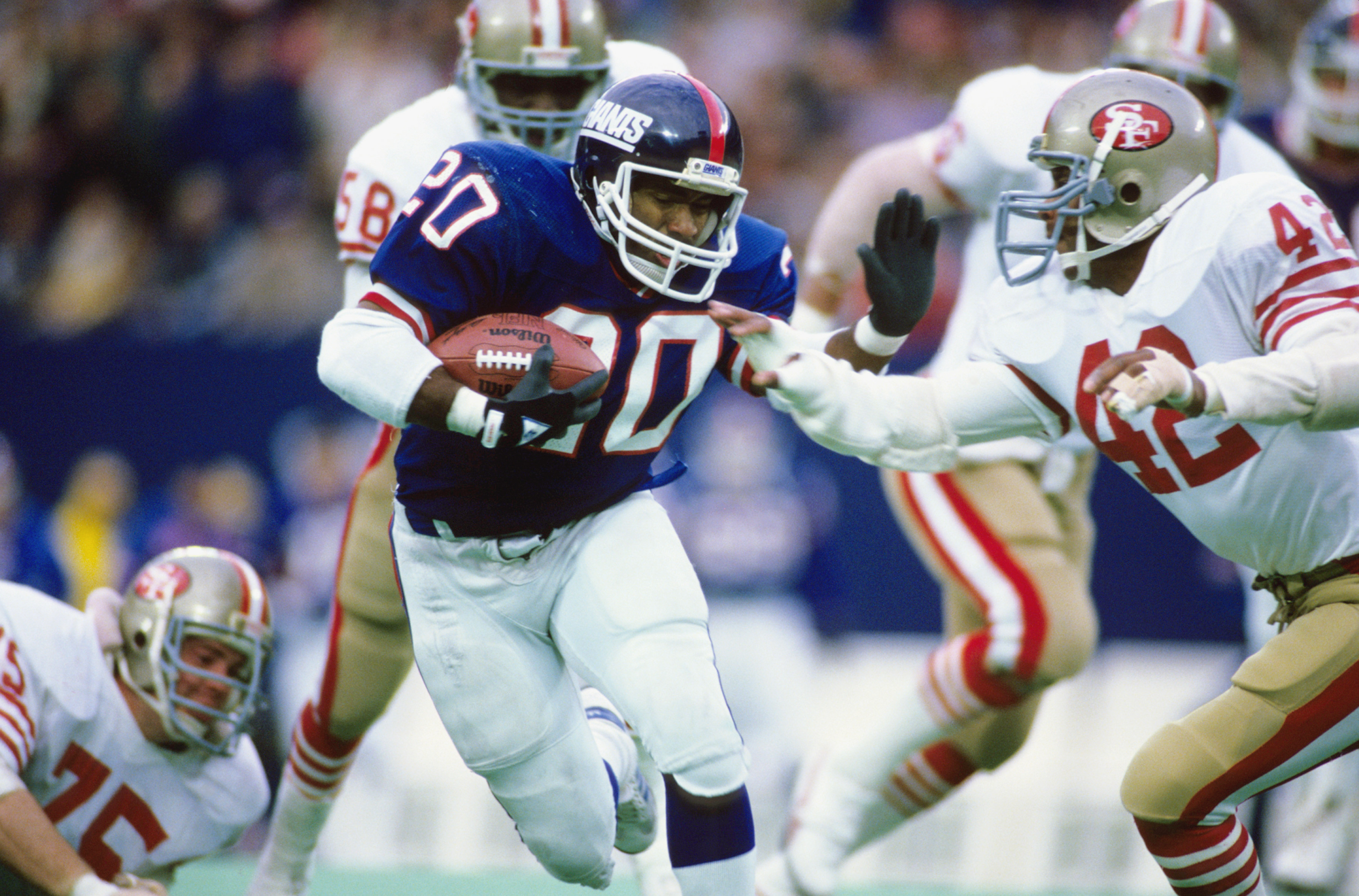 EAST RUTHERFORD, NJ - DECEMBER 29: Joe Morris #20 of the New York Giants carries the ball against the San Francisco 49ers in the NFC Wildcard Game on December 29, 1985 in East Rutherford, New Jersey. (Photo by Ronald C. Modra/Getty Images)