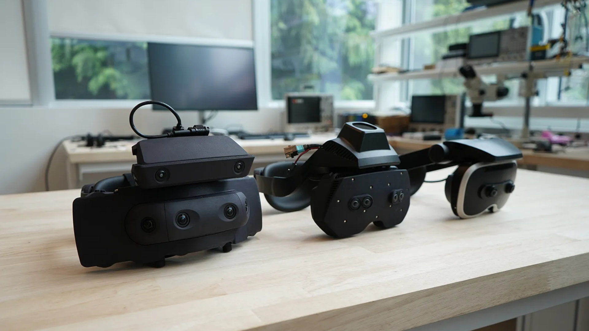 Three Meta VR prototype headsets&mdash;Boba 1, Boba 2, and Boba 3&mdash;arranged in a line on a table.