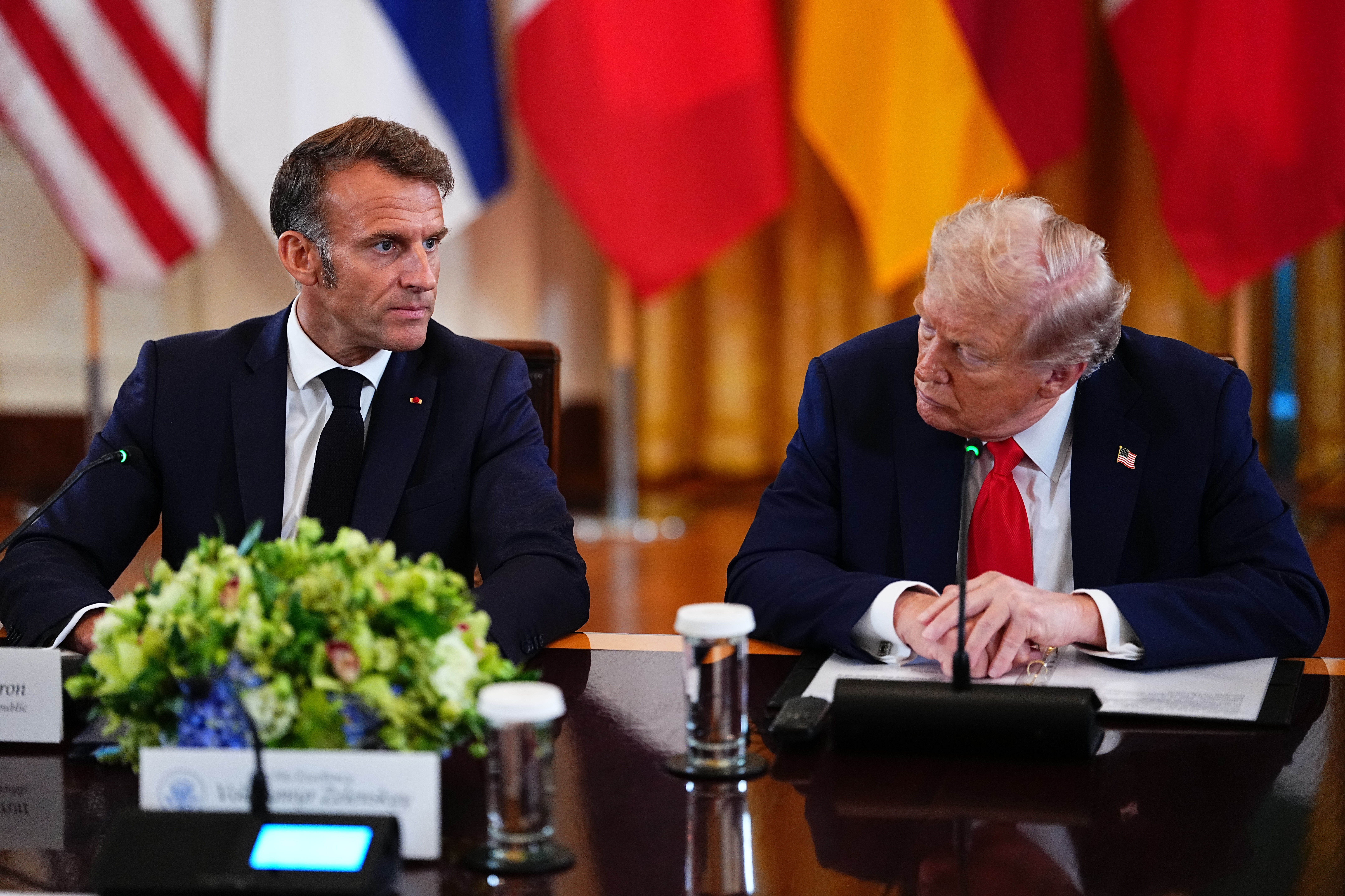 epa12308676 French President Emmanuel Macron (L) makes remarks as United States President Donald J Trump listens as they participate in a Multilateral Meeting with European Leaders in the East Room of the White House in Washington, DC, USA, 18 August 2025. European Leaders are at the White House in support of President Zelenskyy following President Trump’s meeting with President Vladimir Putin of Russia in Anchorage, Alaska, USA, on August 15, 2025. EPA/AARON SCHWARTZ / POOL
