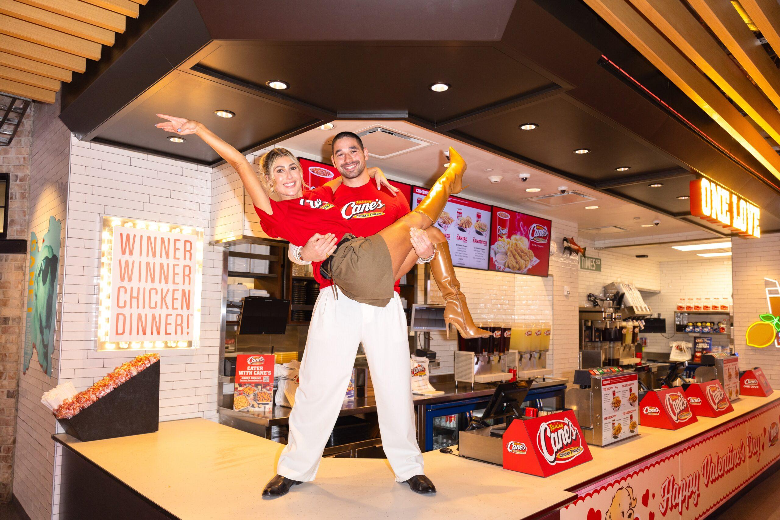 Alan Bersten holding Emma Slater on Raising Cane's counter