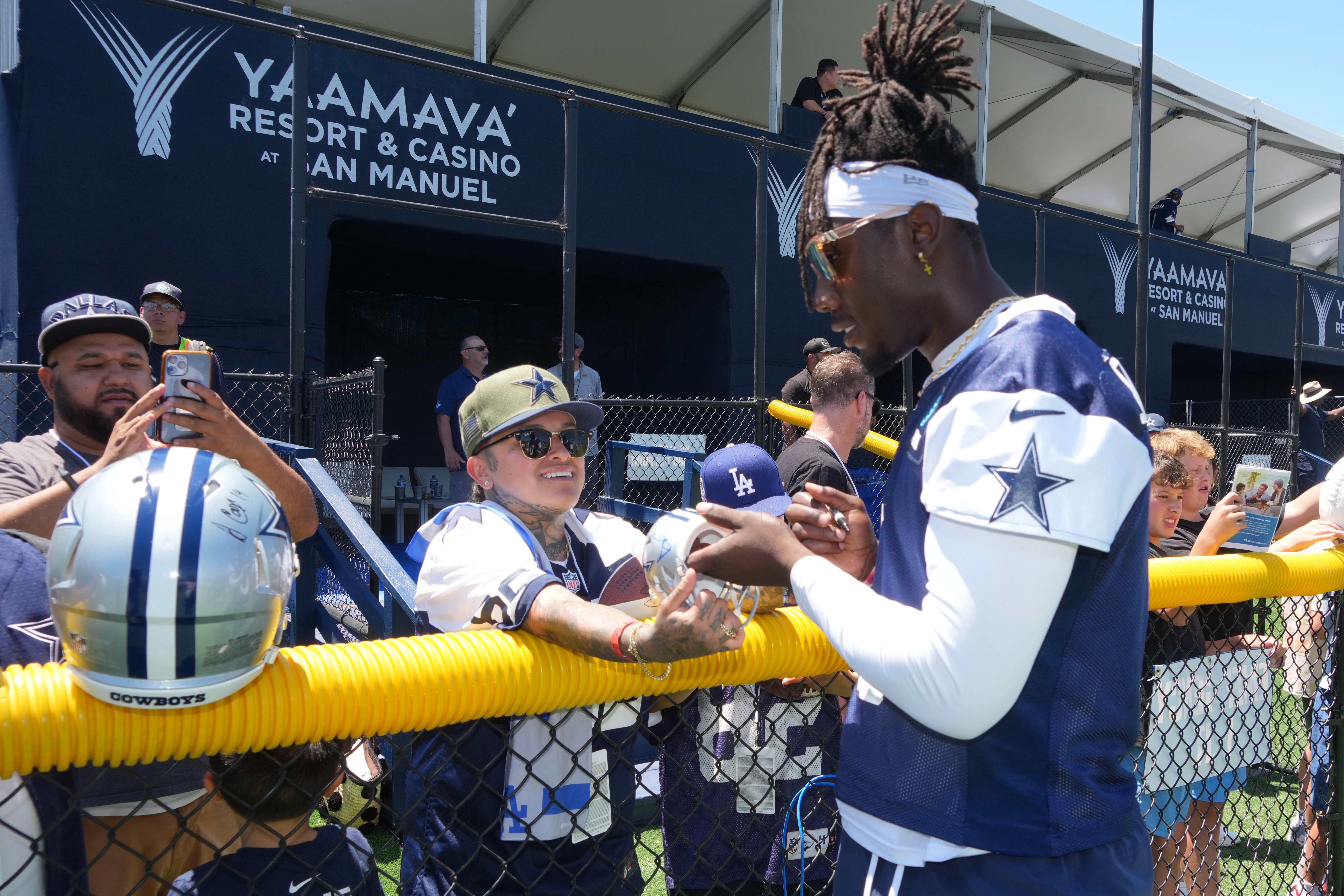 Jul 27, 2025; Oxnard, CA, USA; Dallas Cowboys linebacker DeMarvion Overshown (0) signs autographs at training camp at the River Ridge Fields. Mandatory Credit: Kirby Lee-Imagn Images