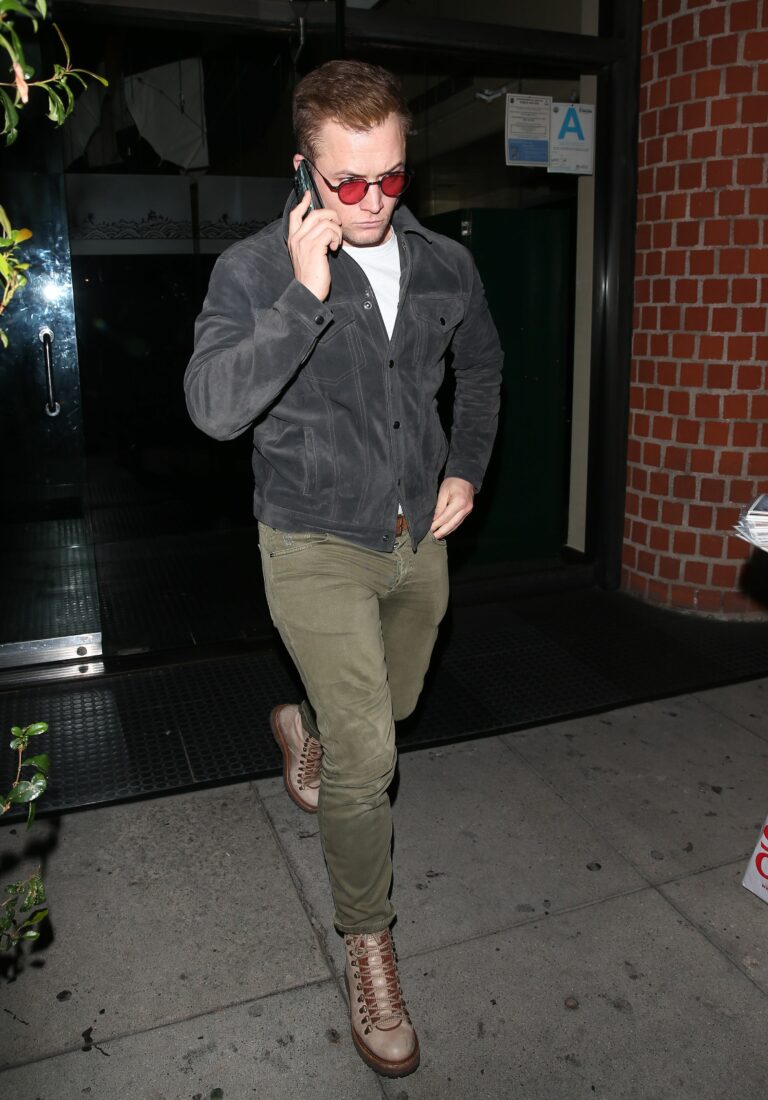 Taron Egerton wears red sunglasses while leaving dinner at apos Mr Chow apos Restaurant in Beverly Hills CA