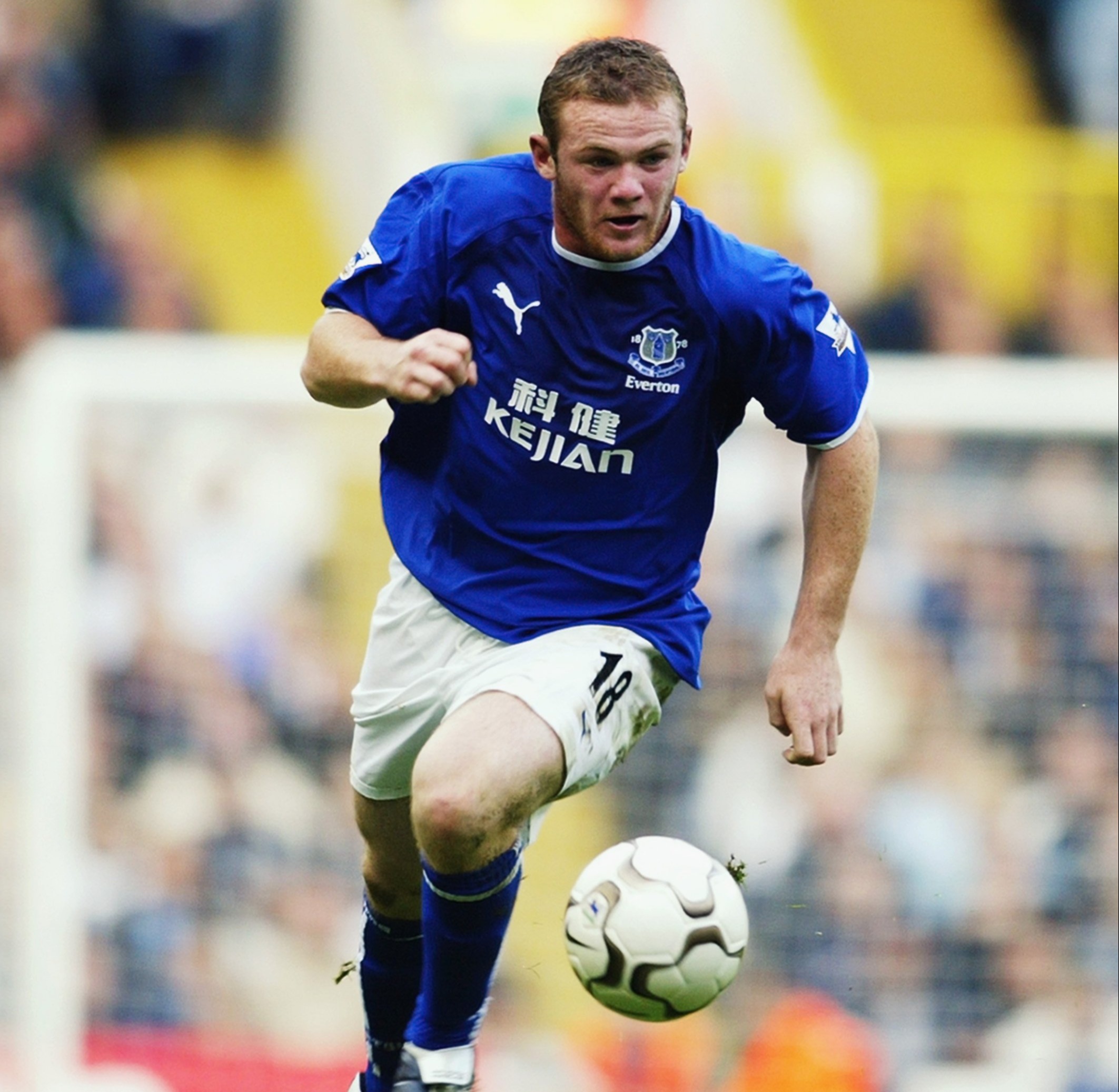 Wayne Rooney of Everton running with the ball during a soccer match.