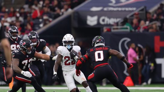 Dec 14, 2025; Houston, Texas, USA; Arizona Cardinals running back Michael Carter (22) runs for a gain past Houston Texans linebacker Azeez al-Shaair (0) during the third quarter at NRG Stadium. 
