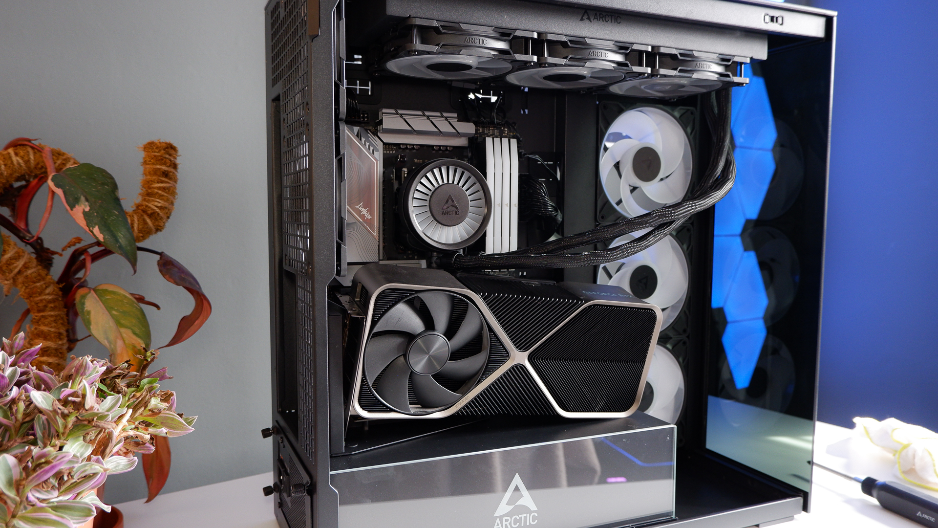 Arctic's Xtender PC case on a white desk with various parts being installed to build a functional gaming PC.