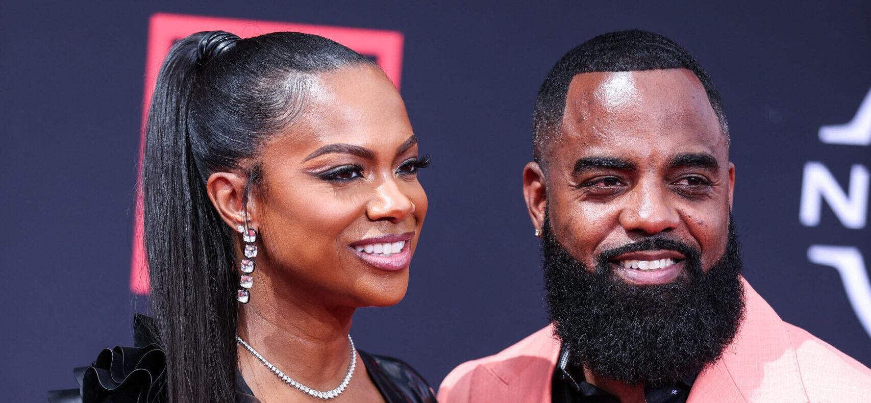 Kandi Burruss and Todd Tucker posing on the red carpet.