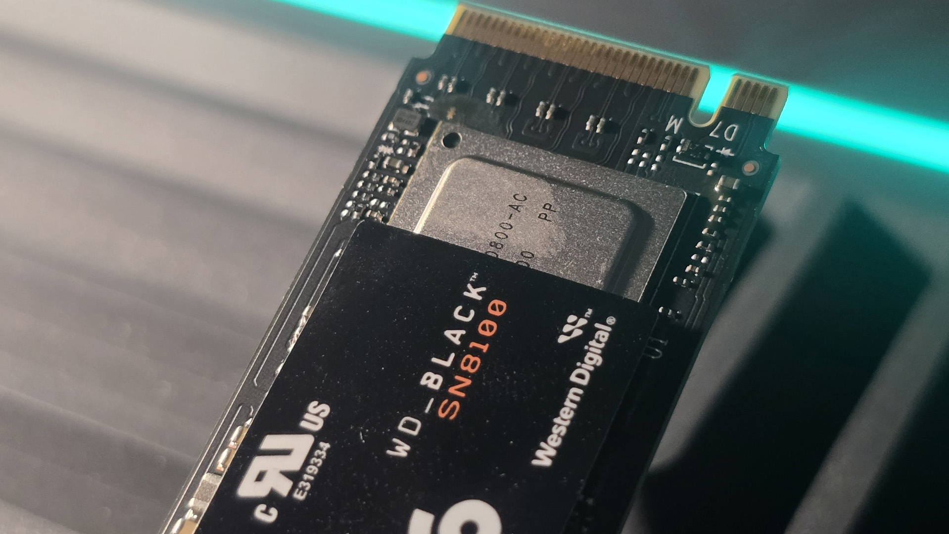 A WD Black SN8100 solid-state drive on a desk and ready to be installed.