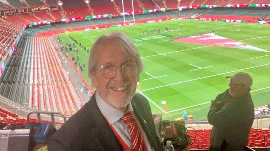 Iestyn Garlick, a man with grey hair and glasses, in a suit stands in the Principality Stadium 