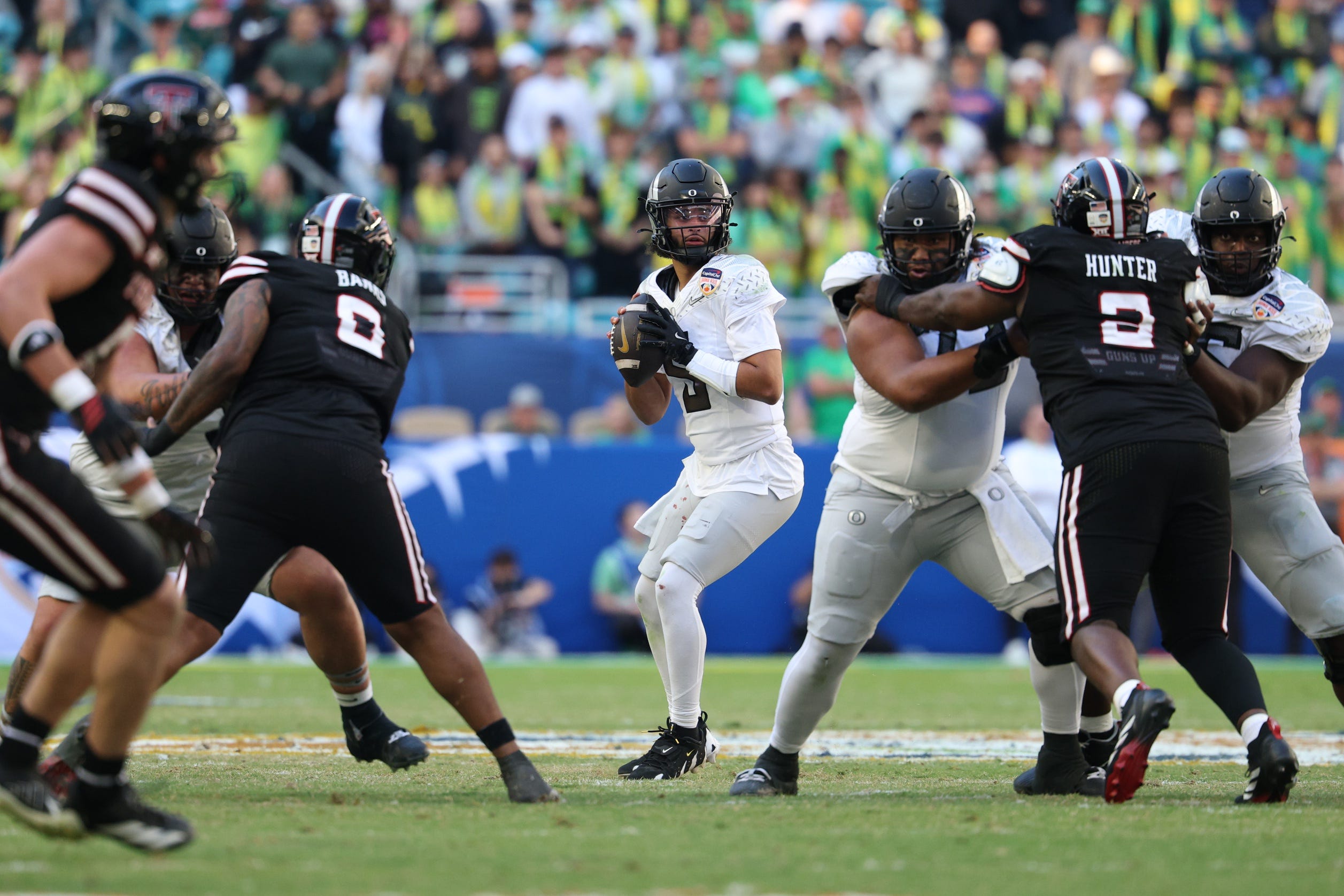 Jan 1, 2026; Miami Gardens, FL, USA; Oregon Ducks quarterback Dante Moore (5) stands in the pocket against the Texas Tech Red Raiders during the second half of the 2025 Orange Bowl and quarterfinal game of the College Football Playoff at Hard Rock Stadium. Mandatory Credit: Nathan Ray Seebeck-Imagn Images