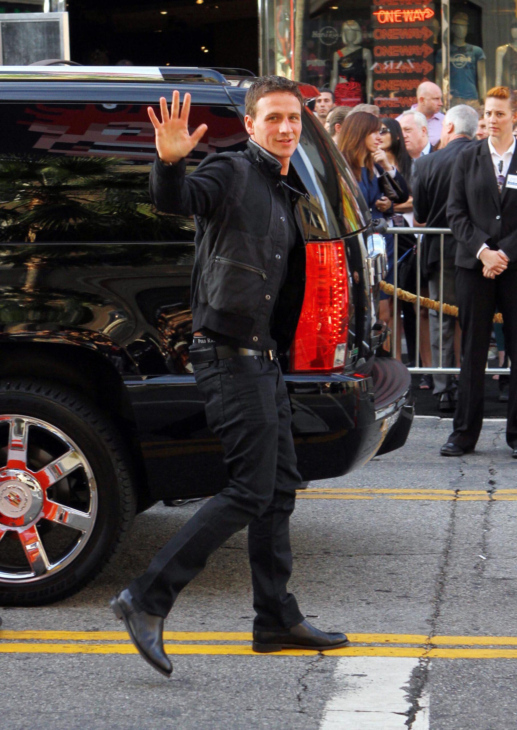 Ryan Lochte posing for pictures outstide.