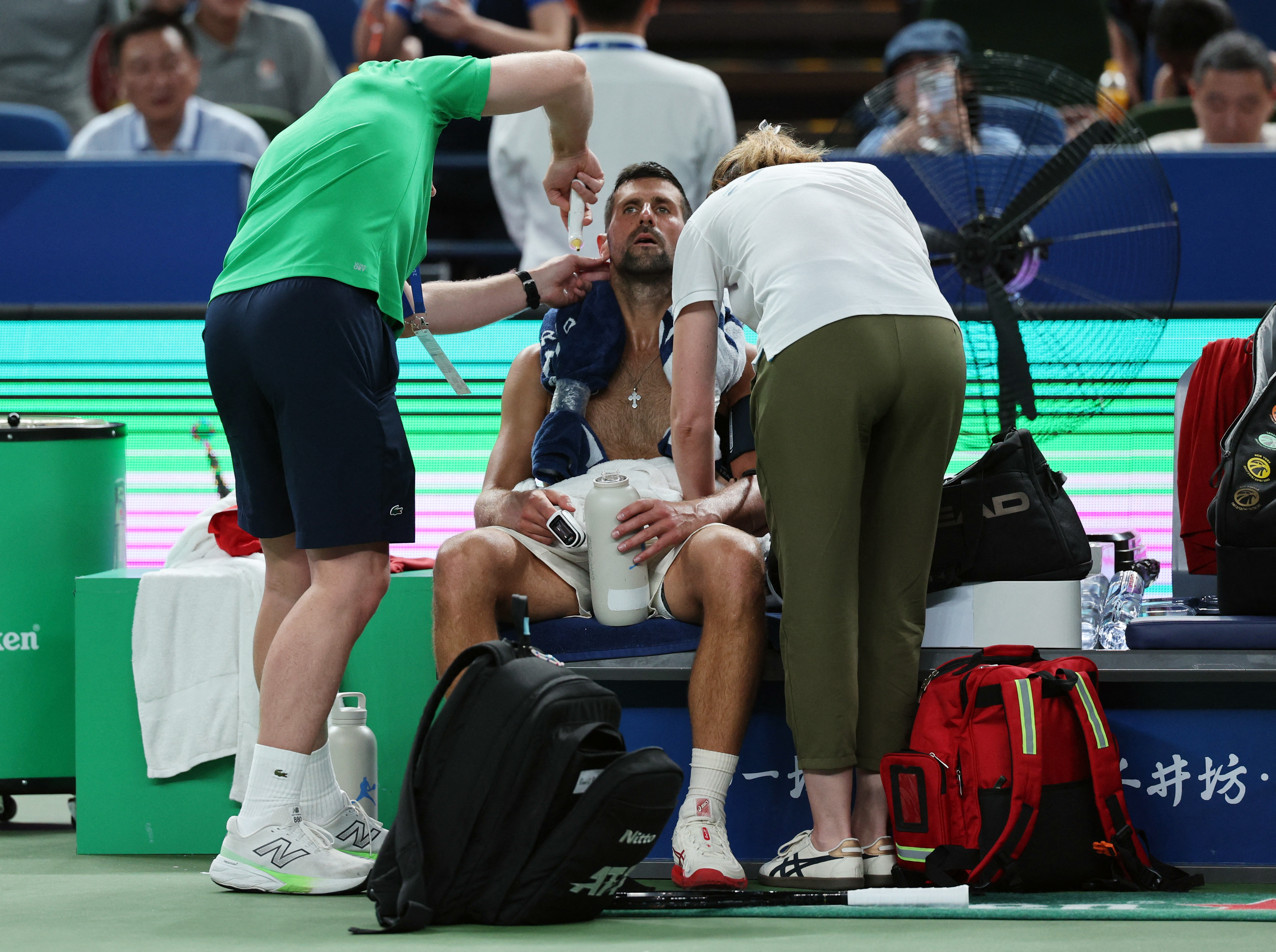 Tennis - ATP Masters 1000 - Shanghai Masters - Qizhong Forest Sports City Arena, Shanghai, China - October 7, 2025 Serbia's Novak Djokovic gets medical attention during his round of 16 match against Spain's Jaume Munar REUTERS/Go Nakamura