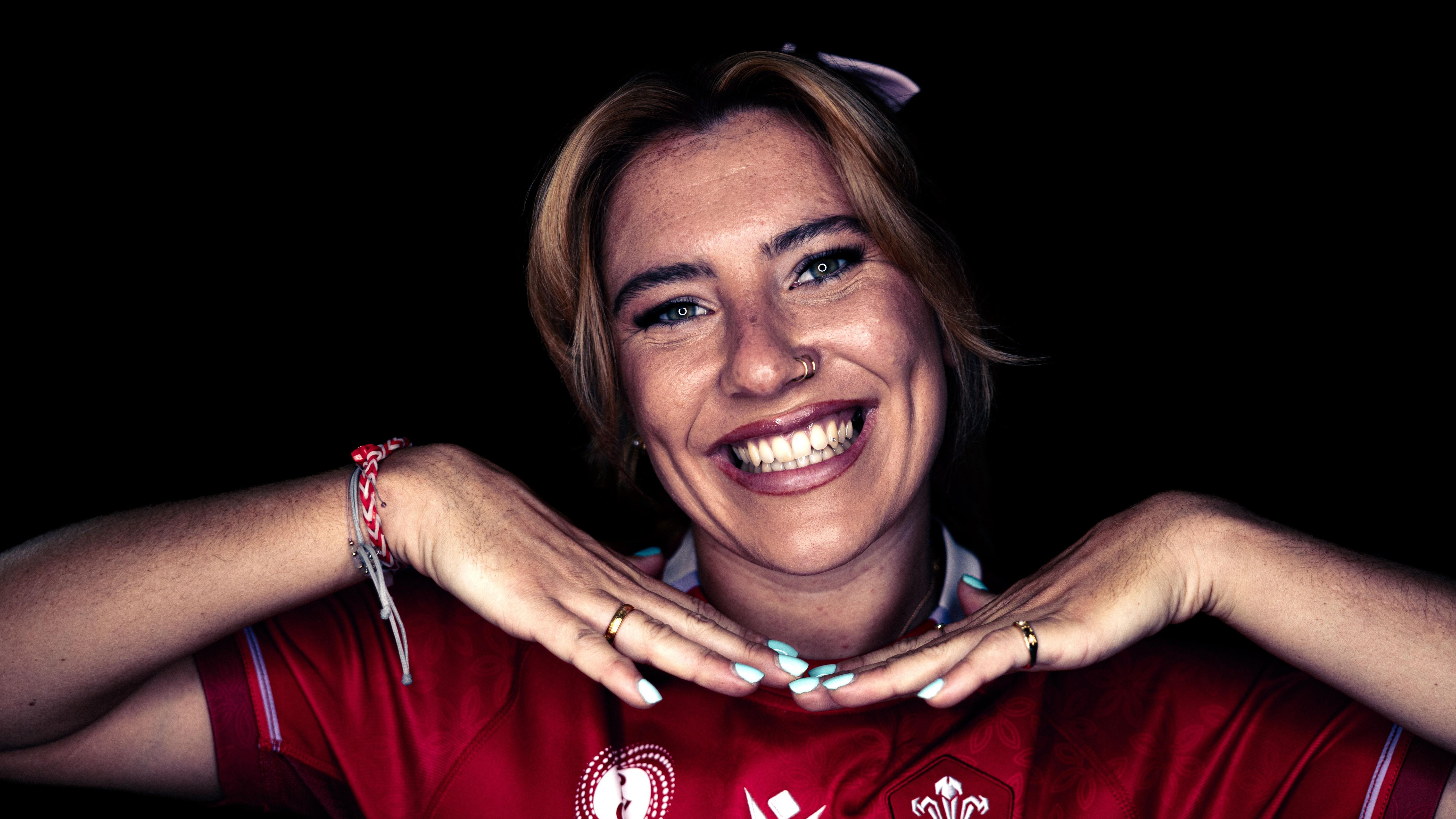 Headshot of Georgia Evans. Her hands framing her face