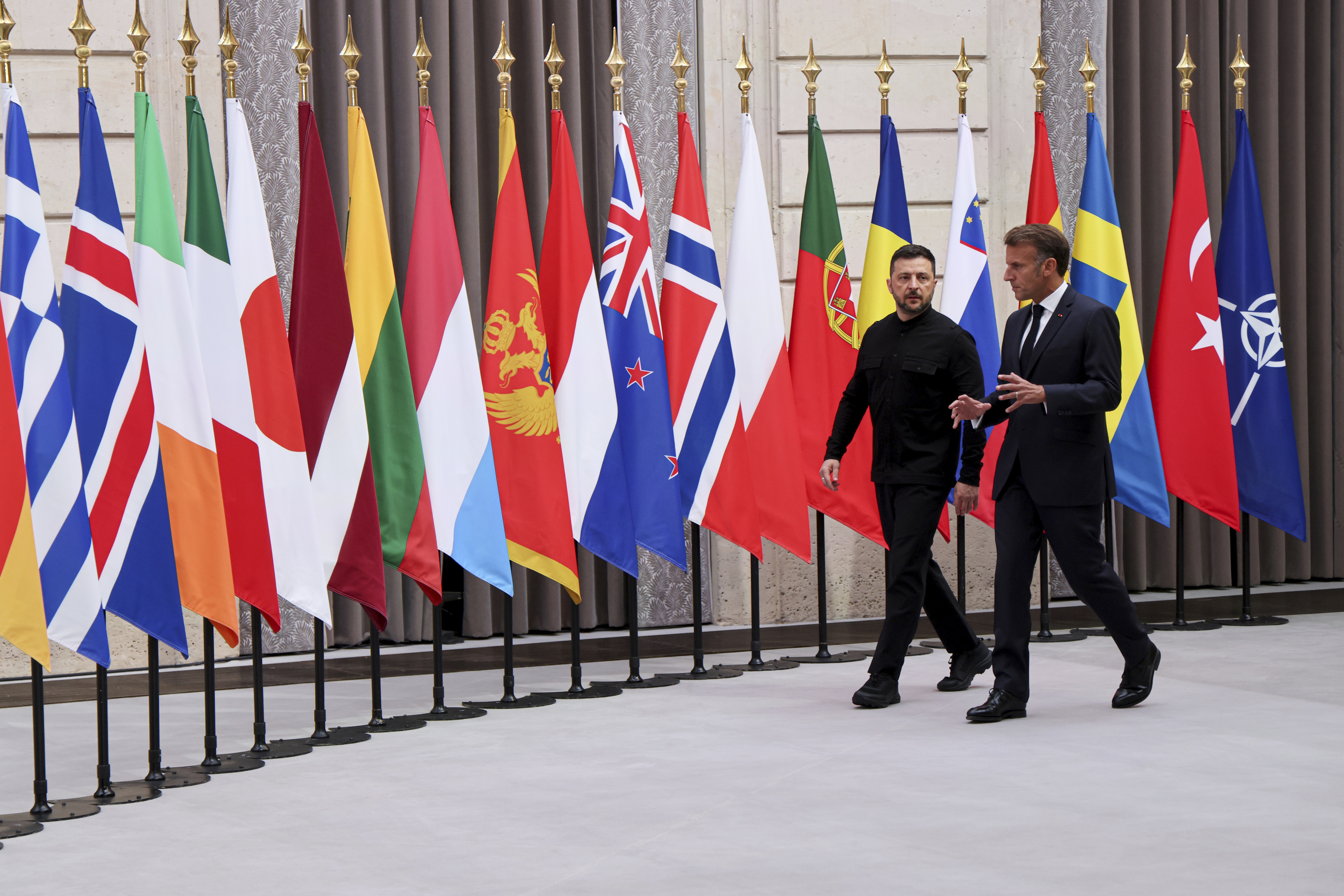 Ukraine's President Volodymyr Zelenskyy, left, and French President Emmanuel Macron, arrive to attend a summit on Ukraine at the Elysee Palace, in Paris, France, Thursday, Sept. 4, 2025. (Ludovic Marin/Pool Photo via AP)